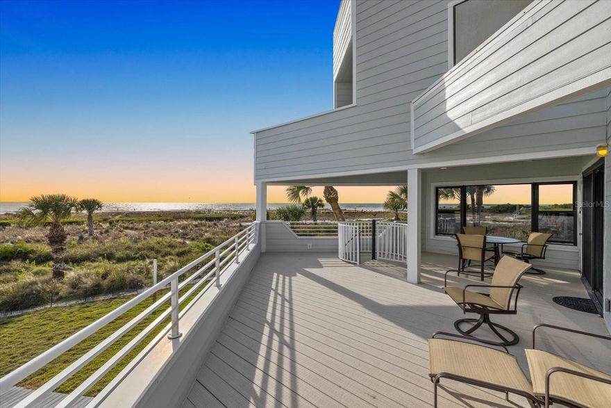 A truly one-of-a-kind beachfront home with spectacular western-facing Gulf views, this is one of only 7 homes on private Tenacity Lane at the north end of Siesta Key.  A few steps along your private backyard path lead you to the powdery white sands of Siesta Key Beach.  Built with the main living areas above county elevation requirements, the home captures sweeping beach-and-ocean panoramas from nearly every room. The living room features a stone fireplace, soaring ceilings, and a wall of sliding glass doors that frame the Gulf and fill the space with natural light. The kitchen and dining area also afford water views and include stainless steel appliances, a gas cooktop, built-in oven/microwave, and a wet bar—ideal for entertaining.  A standout feature is the upper loft overlooking the beach with its own private deck for an even higher vantage point. The spacious primary suite includes a beach-facing alcove—perfect for a private office or reading nook—along with a large bath with dual sinks, a jetted tub, a separate shower, and a private balcony. Two additional bedrooms are generous in size with large windows, en-suite baths, and water views.  Outside, the expansive beachfront deck is partially covered and provides scenic space for grilling, stargazing, or simply enjoying the beach view.  The ground level houses a two-car garage, abundant storage, and a full bath.  The expansive driveway accommodates parking for 12+ vehicles, alongside a large covered outdoor space for relaxing in the shade.  Zoned Residential Multi-Family and offered furnished, this private, direct beachfront property is just steps to Siesta Key Village, renowned for it’s nightlife, dining, shopping, and entertainment. The true value of this property is in the land - it's location, direct beach frontage and access.  This is an exceptional opportunity to enjoy as-is, renovate, or reimagine entirely.  A prime Siesta Key setting with endless potential—a truly rare opportunity to secure a legacy property and create something extraordinary on one of Florida’s most coveted stretches of sand.