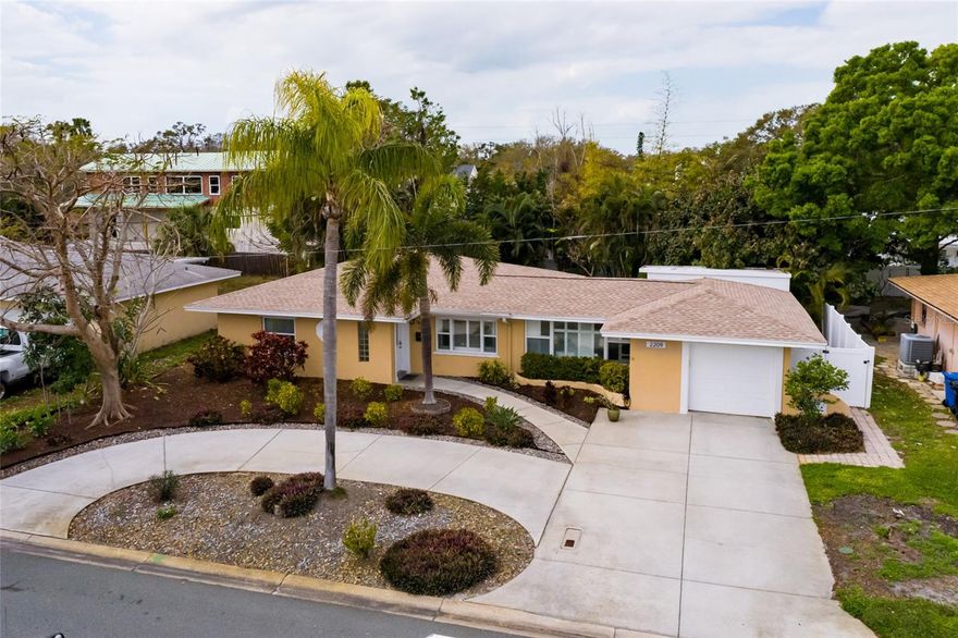 Private Tropical Living in the Heart of Tropical Shores.  Welcome to this beautifully updated 3-bedroom, 2-bath residence in the sought-after Tropical Shores neighborhood, just moments from the waterfront at Lassing Park. Thoughtfully designed living space, this home blends warmth, character, and modern comfort in one of St. Petersburg’s most charming coastal communities.  Inside, bright open spaces create an inviting flow ideal for both everyday living and entertaining. Architectural details such as graceful archways and French doors add character, while plantation shutters and updated luxury vinyl flooring provide a clean, cohesive look throughout. The living room has been enhanced with custom built-in cabinetry, floating shelves, and a stylish electric fireplace feature wall, creating a natural gathering place at the heart of the home.  The kitchen is both functional and elegant, featuring flat-panel wood cabinetry with buffet storage, granite countertops, a glass mosaic backsplash, under-cabinet lighting, and Bosch appliances including a built-in convection oven and cooktop with range hood. The adjacent dining and living areas connect seamlessly, making the space feel open yet intimate.  Both bathrooms have been tastefully remodeled, and the primary suite offers comfort and privacy. A versatile fitness/sunroom overlooks the backyard and provides the perfect flex space for workouts, a home office, or a quiet retreat.  Step outside and discover the true highlight of the property — a private tropical oasis designed for relaxation and entertaining. The saltwater pool is surrounded by pavered decking, a meandering stone wall, and pebble path accents that enhance the lush landscaping. A gas fire pit seating area and outdoor shower add to the resort-style ambiance, while white vinyl fencing ensures privacy. The screened porch offers shaded comfort on warmer Florida days. Additional features include a circular driveway in addition to the attached one-car garage, reclaimed-water irrigation, and French drains.  Located just a short stroll to Lassing Park’s waterfront walking paths and paddleboarding, and minutes from vibrant downtown St. Petersburg, this home offers the perfect balance of privacy, style, and coastal lifestyle.