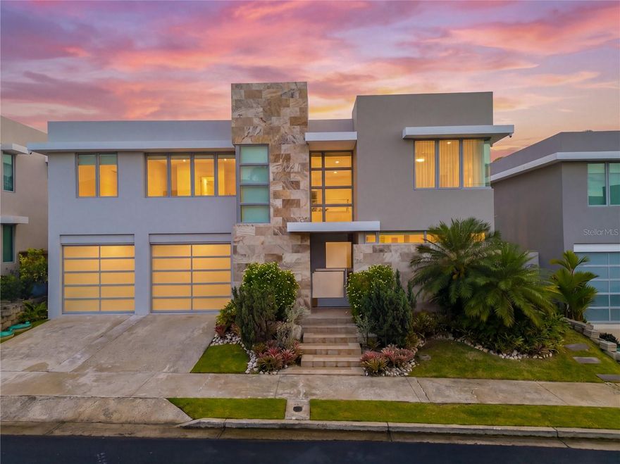 Exclusive, two-story residence located in the private, double-gated community of Senderos de Montehiedra, San Juan. This modern home is designed for efficiency, comfort, and elevated living, featuring 40 solar panels, SONNEN battery backup system, full power generator, electric vehicle charging stations, and water cistern.

The property welcomes you with a striking façade, lush landscaping, and an oversized stainless steel pivot door. Inside, enjoy an open-concept layout with living, dining, family room, and a bright kitchen filled with natural light. An expanded covered terrace opens to a private outdoor space. 

Interior features include: 4 spacious bedrooms, 3.5 bathrooms, laundry room, and a private gym. The home also offers a 2-car garage plus additional driveway parking, A/C units, and stainless steel kitchen appliances. A unique interior hatch provides convenient access to the rooftop.

Located within Montehiedra West, a double-gated community with 24-hour security and patrol. Residents enjoy access to Las Gaviotas Casa Club, pools, tennis and basketball courts, parks, and more. Prime location near top schools, shopping, restaurants, and major highways.

Shown by appointment to qualified buyers.