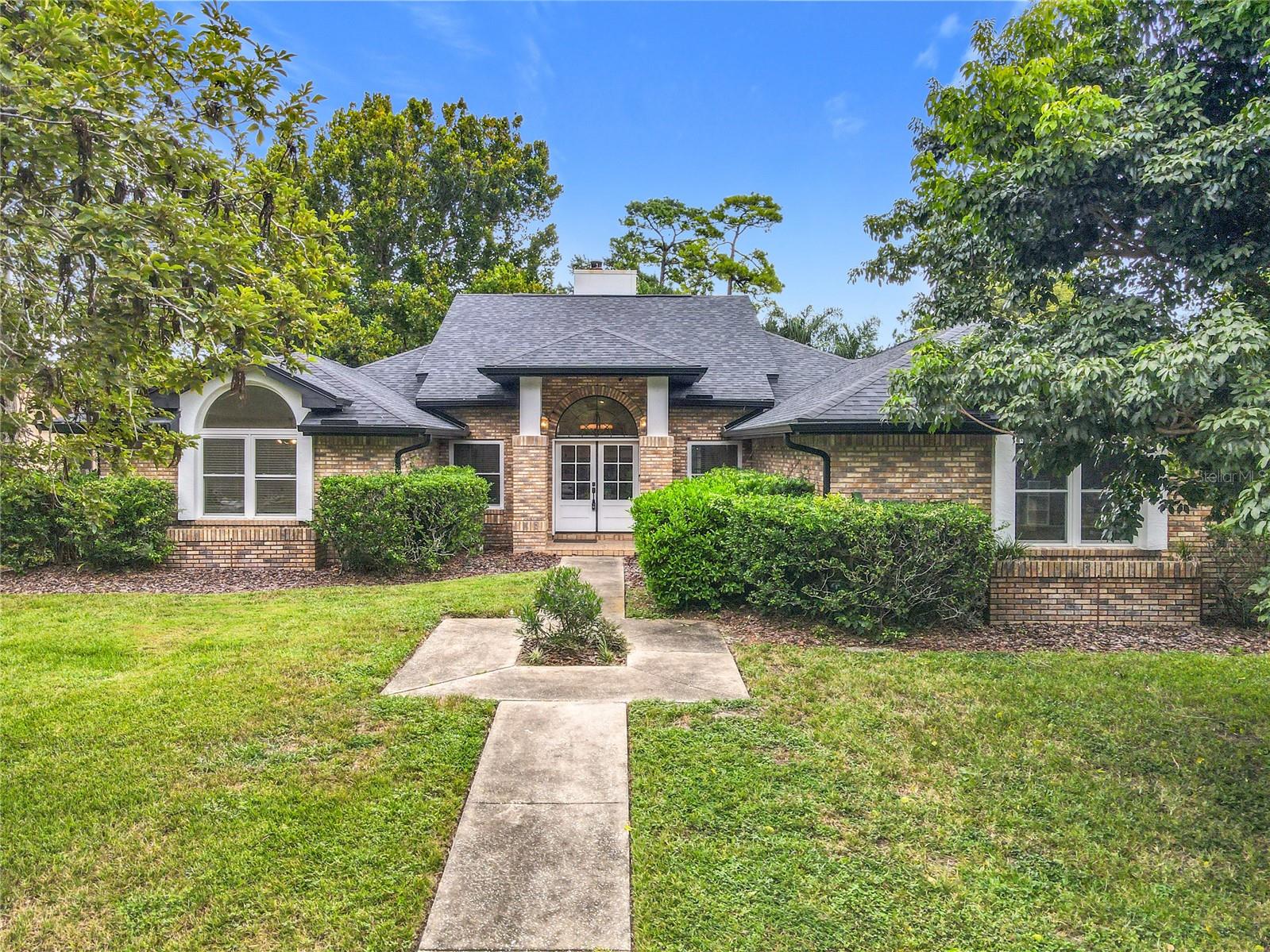 Welcome to this stunning 4-bedroom, 3-bath ranch-style pool home in the highly desirable Tuscawilla-Chelsea Woods neighborhood of Winter Springs. Nestled on a generous 1/3-acre lot surrounded by tree-canopy-lined streets, this residence has been completely updated to combine timeless character with modern elegance. Step inside to soaring cathedral ceilings, a split-bedroom layout, and an expansive great room featuring a brick-faced, wood-burning fireplace and French doors that frame serene views of the screened-in pool and lanai. The remodeled chef’s kitchen is a true showpiece, offering custom 42" Wellborn cabinetry, soft-close drawers, an oversized quartz island with seating and storage, range with pot filler, and top-tier stainless steel appliances. Two spacious primary suites make this home ideal for multigenerational living or hosting guests, each with French doors to the lanai, walk-in closets, and spa-inspired baths. The luxurious bathrooms showcase designer tile, frameless glass showers, dual vanities, and high-end finishes. Perfect for entertaining, the open-concept kitchen, dining, and living spaces flow seamlessly outdoors to the covered lanai and sparkling resurfaced pool (2021), creating your own private retreat. Notable updates include roof and skylights (2021), double-pane thermal windows (2019), water heater (2019), whole-home re-pipe (2019), pool resurfacing (2021), and new AC system (2025). Outside, enjoy the oversized fenced backyard, extra-long driveway, and no HOA. Located in one of Central Florida’s most sought-after communities, residents appreciate easy access to golf, trails, shopping, dining, and top-rated schools including Lawton Elementary, Indian Trails Middle, and Oviedo High. This rare opportunity offers space, style, and substance — don’t miss your chance to own a Tuscawilla pool home in Chelsea Woods.