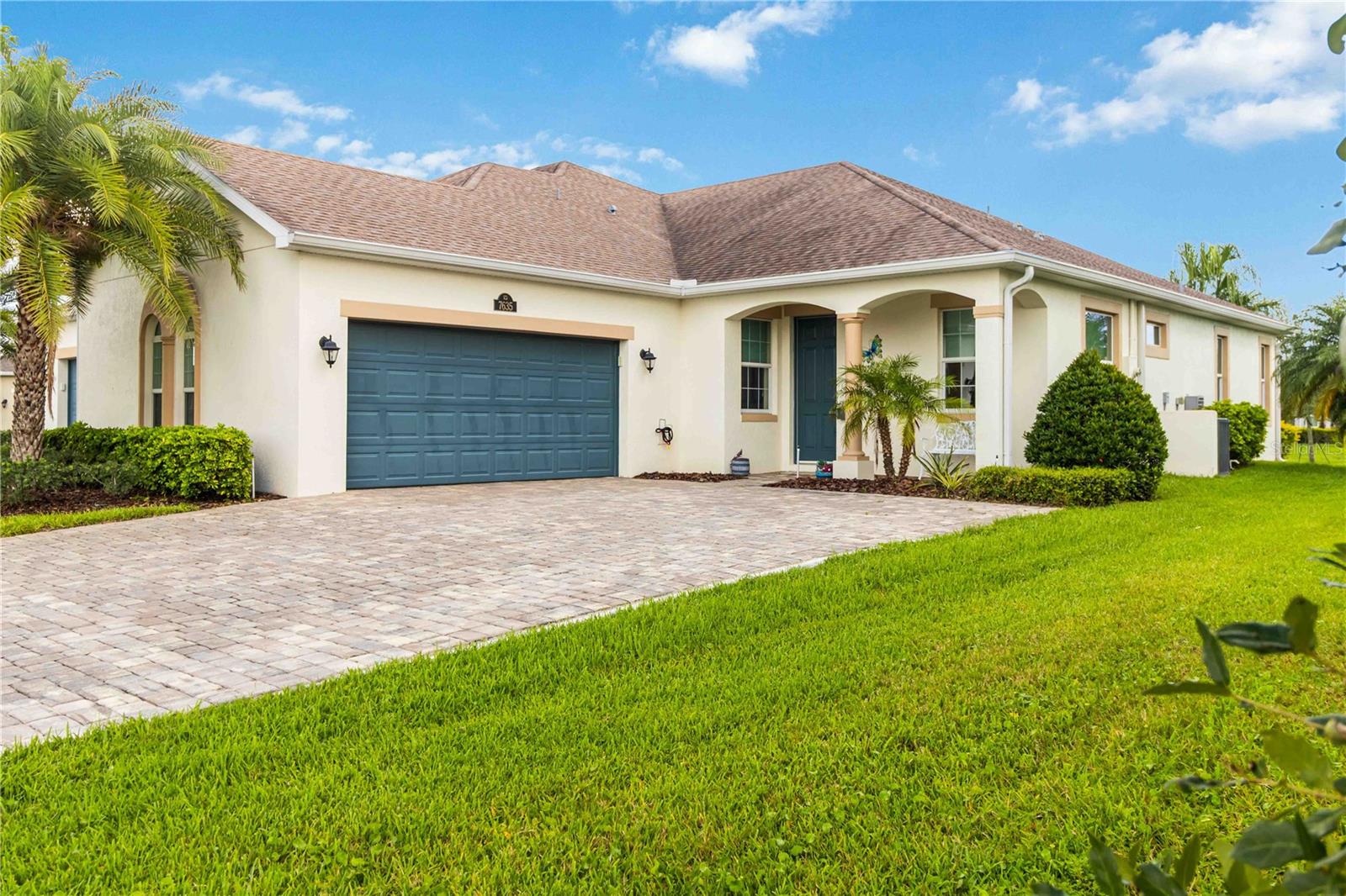 Welcome Home! This thoughtfully designed home offers modern upgrades such as high quality wood-look tile flooring, stylish lighting, upgraded 8 ft wide doors & crown molding. The open floor plan presents a spacious living room that flows seamlessly into the chef-inspired kitchen & dining room. Light & bright kitchen boasts quartz countertops, tile backsplash, pantry, large island/breakfast bar, stainless appliances (including new LG ThinQ fridge), an ideal space for entertaining. Owners suite w/en suite bath features double vanity & walk-in tiled shower. Triple sliders open to the brick paver, screened-in patio w/serene WATER VIEW & large yard. Waterview from front porch provides additional privacy. Living here is truly maintenance free, giving you more time to enjoy the resort-style amenities! This home offers comfort, convenience & community. Conveniently located near shopping, dining, movies, hospital, 20 min to beaches, 40 min to KSC, NASA, SpaceX, Blue Origin, 45 min to Orlando!