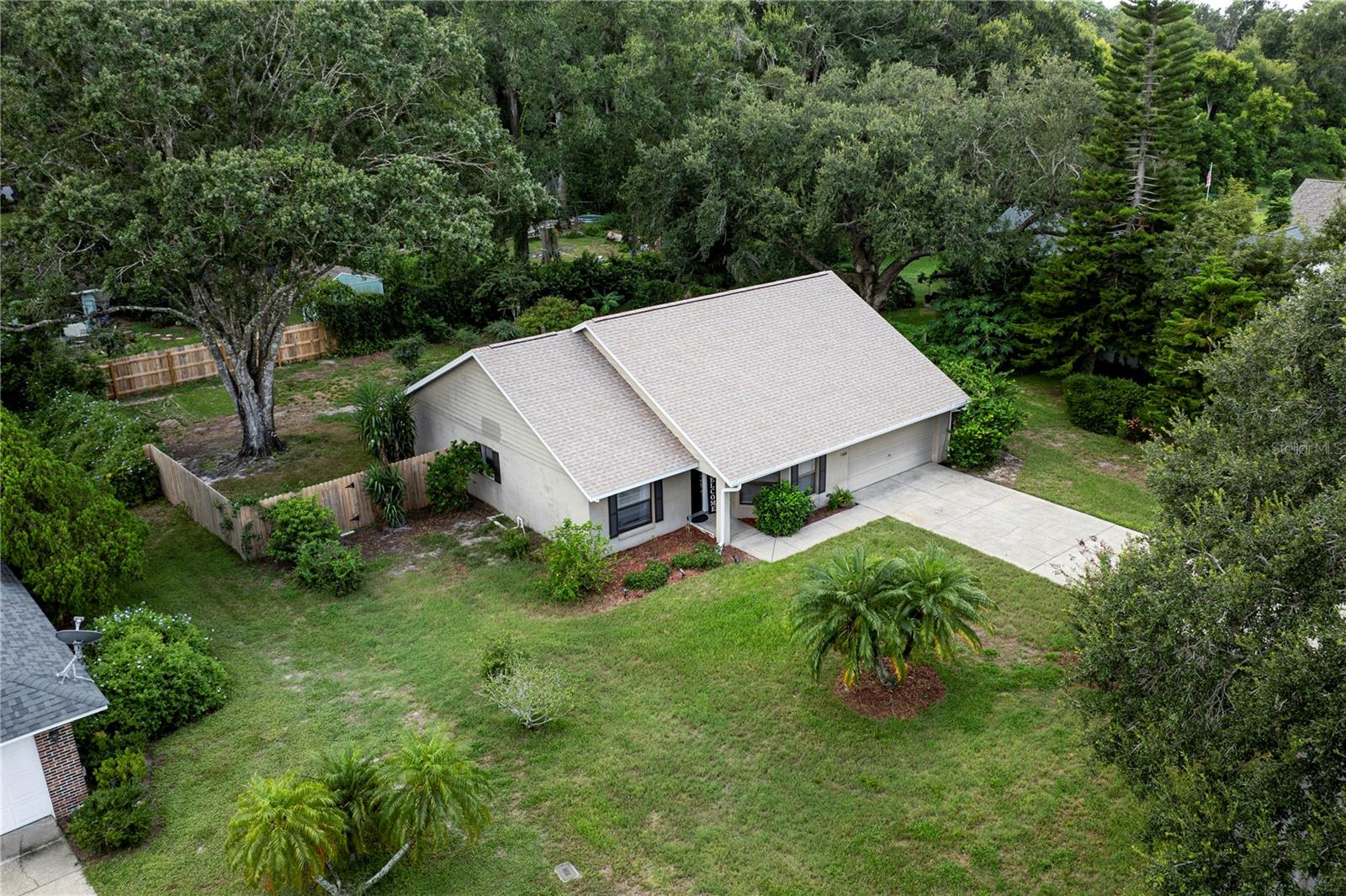 Welcome to 4180 Wood Drive, a beautiful home located in the highly sought-after community of Park Wood of Mount Dora. This lovely home features 1,463 square feet with three bedrooms, two bathrooms, and a two-car garage. A new roof was installed in September 2025. The property sits on an oversized lot with a fenced backyard, perfect for entertaining family and friends on the screened-in back porch or around the fire pit. As you enter the home, you'll immediately notice the split floor plan, vaulted ceilings in the living room, and French doors leading to the screened porch. The spacious kitchen is perfect for entertaining, with beautiful cabinetry, abundant counter space for food prep, and ample storage. All kitchen appliances are included. The home features laminate and tile floors throughout, with no carpet. Your primary bedroom includes sliding doors for natural lighting and direct access to the back porch, a large walk-in closet, and an en-suite bathroom with a stand-up tiled shower and dual sinks. The quiet and peaceful Park Wood Community is centrally located and close to everything that Lake County has to offer. You will have just a short drive to Downtown Mount Dora, Downtown Tavares and the conveniences of local restaurants, shopping and major highways. Do not miss your chance to call this home! All information recorded in the MLS is intended to be accurate; however, it should be independently verified by the buyer and their agent.