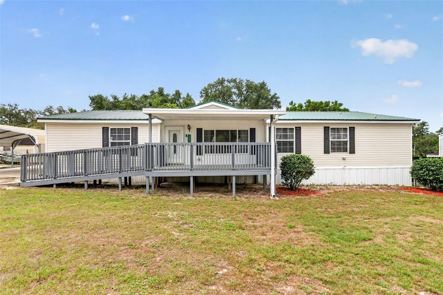 Looking for an affordable place to call Home with NO HOA , Lot Rent, or Water & Sewer Bill?  Then this 3/2, almost, 1800 Sq Ft  Modular home on your private lot with Well and Septic is a must see option. This immaculate Home offers
a large 11X16 Front Covered Porch with soft approach incline ramp allowing for easy wheelchair accessibility.  Open
the front door and enter a large Open Concept floor plan featuring Vaulted ceilings throughout. The first room can be
utilized as a Formal Living Room, Work Space, or Game room, large enough for that Pool Table! This area features
Laminate flooring that also leads in to your spacious Dining Area, Family Room with built In TV and Book Shelves as
well as a generous sized Kitchen with plenty of Cabinets with that must have double kitchen sink.  Here you'll find Oak
Cabinets and white Appliances plus plenty of natural light.  Needing more light to cook, flip a switch for your overhead
ceiling spot lights!  Continue through the Kitchen into your separate Laundry Room with Washer and Dryer. This area
also offers a rear back door Exit opening onto your 10X16 Deck overlooking the Fenced Back Yard. Perfect for Pets!
The other side of the Laundry room opens into a full Guest Bath Room with large Vanity, as well as a walk in Shower.
Convenient to both access from the rear deck and Hall Entry from your two Guest Bedrooms. The Primary Bed Room
En-Suite has those Vaulted Ceilings, Large Walk In Closet, plus, a Spa Inspired Bath complete with a Corner Garden
Soaking Tub, Double Sink Vanity, Stand alone Shower and a matching Linen Cabinet. No Space wasted in this Home.
At the end of the Bedroom Hall you'll find a Built in Desk Area offering wall Cabinets, as well as, multiple desk drawers 
and side desk cabinet. Just enough space tucked away for your Home Office. Did I mention, all three Bedrooms have
walk in closets, so much storage space! The Bonuses continue outside where you'll have covered parking for two cars
under your large Carport with Cement Foundation. The drive way also has room for additional parking as well. Beyond
the Carport is a large CLEAN Workshop complete with workbench and, an additional Storage building that houses the
Well Pump keeping it out of direct sunlight. This building is perfect for lawn equipment, bikes, or just additional storage
items. Both these buildings open to the rear yard as well. This well kept Home offers an appealing peaked Metal Roof,
giving you years of peace of mind. Come take a look at all this property has to offer. The possibilities are endless.