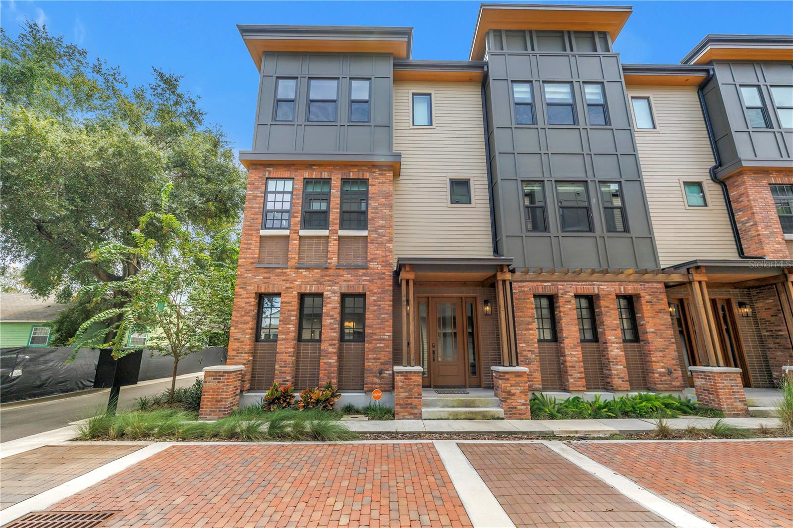 One or more photo(s) has been virtually staged. Welcome to this three-story masterpiece that exemplifies design and craftmanship. Located in the vibrant neighborhood of Tampa Heights, this home has great curb appeal with stunning architectural style featuring shale and brick accents and a Redwood entry porch. This home has engineered Oak hardwood flooring throughout. The first floor has a bedroom with designer wallpaper, closet with a built-in and a full bath. This bedroom could also be used as a home office. Both staircases in this home are stunning with open custom steel with Oak treads. With an open concept living, the second floor is the main living area featuring a gourmet kitchen, breakfast nook, half bath, dining and living areas. The kitchen has custom solid wood cabinetry, Quartz counters, stainless steel appliances, pendent lighting, walk-in pantry and gorgeous glass tile backsplash. This living room has a built-in with a wine refrigerator. The third floor of this home has the primary suite, secondary bedroom with a full bath and a laundry closet. The primary suite has a large custom designed walk-in closet. The primary bath has double sinks, water closet and a walk-in shower with dual shower heads. Completing this home is an attached 2-car garage with an electric vehicle charging station. Built to last, this steel framed home is hurricane and termite resistant. Not in a flood zone, this home is located in one of the city’s most dynamic neighborhoods and it is close to sought after destinations such as Riverwalk, Armature Works and Downtown Tampa.