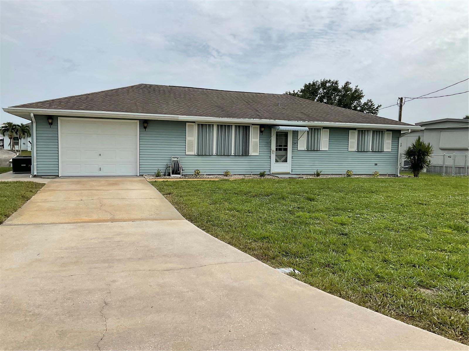 Taylor Creek Isles- Looking for the perfect winter retreat look no further than this Well maintained 2-bedroom 2 bath home with Lake Okeechobee access. Features include covered boat house with dock, & lift, good seawall, private boat ramp, cozy family room, Florida room, spacious kitchen and dining room combination with beautiful built-in hutch, inside laundry, tons of storage space, oversized one car garage, sprinkler system off canal, 2017 Central Air, 2017 Shingle roof, and more. Minutes to Lake Okeechobee, dining and shopping. Property is being sold Turnkey. 4-point and appraisal available. Call today! All measurements approximate