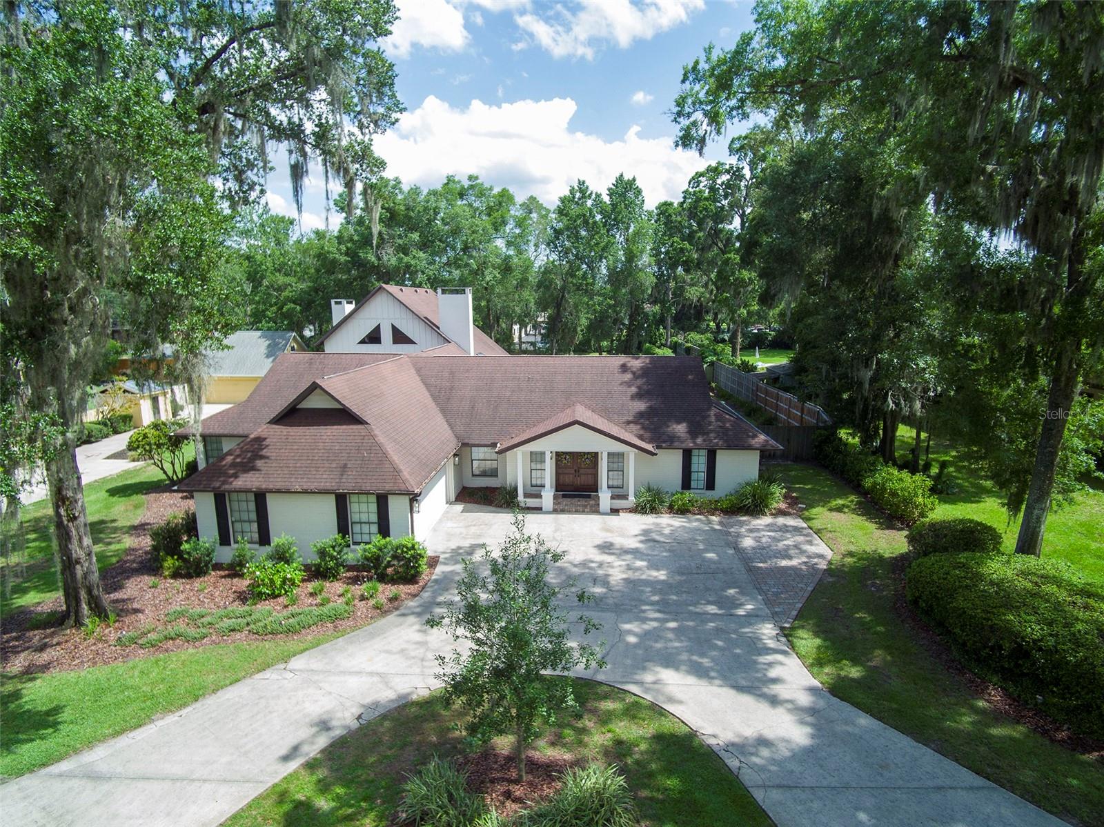 Beautiful pool home in the highly sought after Woodfield Neighborhood Area is ready for you to move in! This is a rare find for sure! Located on over 1/2 acre with 4550+ sq ft of living space, this home has room for everything. This completely renovated home boasts 4 bedrooms, 4 1/2 bathrooms, home office, 3 separate family/living spaces, 2 kitchens, in home gym and sauna, loft bedroom with additional mezzanine room, upstairs storage room, inground saltwater pool, outdoor shed, Generac generator, 2 gas fireplaces - the list goes on and on! Updates include 3 new ac units (2020), new gas line (2023), pool resurfaced (marcite - 2020), new roof (coming 2025), new flooring throughout (solid hardwood, marble, tile, waterproof backed carpet), all new cabinets, countertops and appliances (2020), new water heaters (2020), Generac generator serviced (2024), Lanai Rescreened (2021), new garage door (2024). Entertaining large gatherings of friends and family is a breeze with the 3 family/living areas, large pool with covered lanai and fenced backyard. Do not miss out on living in this stunning home in a super friendly neighborhood! It's all you could ever want! Make it yours today!