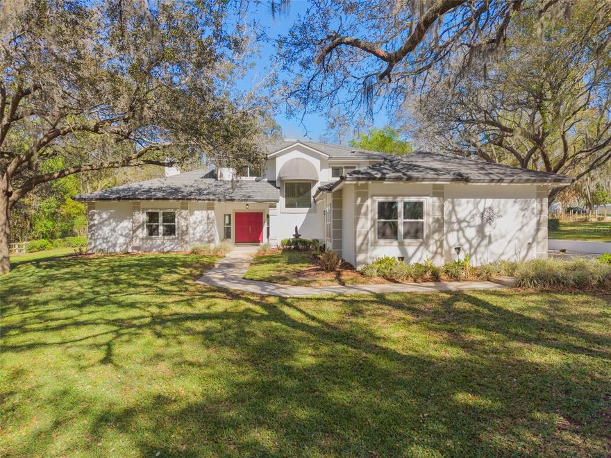 Priced below appraisal.  Welcome to 1805 Meadowbend Dr, a small gated enclave of 6 estate homes. This impressive property offers a unique blend of country living within city limits. Spanning over 4,000 sq ft on a sprawling 5-acre lot, this residence is priced at $1,400,000.  The home showcases a downstairs master bedroom complete with a sitting area. The master suite features double California closets and an ensuite bath equipped with a soaking tub, separate shower and vanity with double sinks. Additionally, it provides direct access to the pool area for added convenience.  There are 4 additonal bedrooms and 3 additional baths with one recently updated to be ADA compliant.  The common areas are designed for comfort and entertaining. A combined living-dining room boasts a gas fireplace and large sliders providing picturesque views of the pool. The light-filled chef's kitchen is fitted with double ovens and extensive counters, opening up to the breakfast nook and family room.  More than just functional spaces, these rooms exude charm through details such as built-in bookshelves, big screen TV and surround sound system in the family room. A large bonus room offers further flexibility while leading out to the pool and outdoor covered patio featuring a built-in grill.  
Outdoor amenities include a screened pool, spa and porch overlooking the lovely yard and stables. Equine enthusiasts will appreciate the five-stall stable with tack room, corral, and pasture. Additional structures include multiple sheds and outbuildings spread across the property.  The garage features a sleek look with cabinets for storage and parking that can accommodate four cars.  Sports lovers can enjoy their own lighted tennis court that also includes a basketball hoop. The entire compound benefits from dusk-to-dawn lighting along with an extensive sprinkler system for easy maintenance.  Efficiency has been prioritized in this home’s design with minimal running costs ensured by an installed $30k 11.7 KW peak solar system controlled by an app. Other recent updates include new doors & windows (2020) and metal roof installation (2020). Water heater exchange system.  Water supply comes from a well equipped with water softener, chlorinator and carbon filter ensuring quality supply throughout the house. Safety is prioritized with a monitored security system and a gated community setting.  Longwood, FL offers a plethora of amenities. Enjoy easy access to quality schools, shopping centers, health facilities, recreational parks, and dining options. Its location also provides convenient commute times to nearby cities.  Every aspect of this home has been thoughtfully designed and meticulously maintained to create a truly unique living experience. You are invited to step into this world of comfort and luxury at 1805 Meadowbend Dr.  Termite Bond in effect.  Items that do not convey: Big Cranes and Bear in Garden and Tesla Charger in Garage.