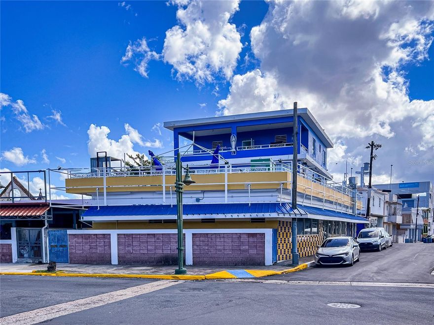 Three-Story Mixed-Use Commercial Building on a double-corner lot with access to three streets: Avenida Las Nereidas, Calle Barbosa, and Calle Santa Rosa in the town of the Municipality of Cataño. The building has 5,118 square feet of construction on a corner lot of 421.758 square meters. The FIRST LEVEL is divided into two (2) commercial units with a total gross construction area of 3,240 square feet. The larger unit is a restaurant specializing in the sale of barbecue chicken with an approximate area of 2,358 square feet. It includes a dining area, kitchen, three (3) half bathrooms, a walk-in freezer, and an office. The SECOND LEVEL, accessible from Calle Barbosa, consists of a residential unit with an area of 925 square feet, including a living room, dining area, kitchen, two bedrooms, and one bathroom. This residence has a closed balcony area of 353 square feet. On this second level includes an exterior half bathroom and a laundry area, both located under the staircase that provides access to the third level of the property. The second level features a spacious open terrace area. The THIRD LEVEL leads to an open balcony area that connects with a covered balcony of 321 square feet. This residential unit has 953 square feet, living/dining room, kitchen, three bedrooms, and one bathroom. This three-story property, on a corner lot, has access to Avenida Las Nereidas, Miguel Santiago Ocasio Convention Center, Cataño to San Juan ferry, the Cataño Boardwalk 'Bahia Viva,' the Government Center 'La Alcaldía,' and other public and private buildings. Beautiful view of San Juan Bay. Prime location. Easy access to main roads PR-165, PR-22. Sale price is 2,200,000.00 (Offers considered) Financial pre-approval or proof of funds required.