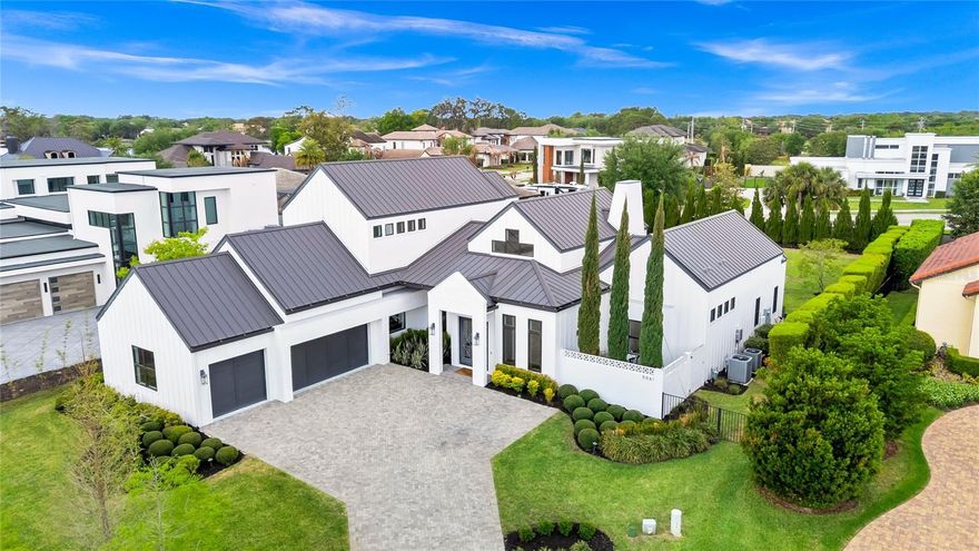 A truly exceptional CUSTOM residence in the gated enclave of SAWYER SOUND, a private neighborhood of 20 luxury homes.  Across the street from Windermere Prep and Windermere High School! This MODERN TRANSITIONAL FARMHOUSE is a rare blend of architectural presence, intentional design, and elevated livability - set on nearly half an acre.

Built in 2020 by Cam Bradford Homes, this home showcases solid BLOCK CONSTRUCTION, a METAL ROOF and a combination of BOARD AND BATTEN SIDING and HAND LAID PAINTED BRICK.  From the moment you enter, SOARING CEILINGS, WIDE PLANK WHITE OAK flooring, CUSTOM BEAM DETAILS, and FULL CROWN MOLDING including 7’ BASEBOARDS THROUGHOUT create a sense of understated luxury.

Designed for both everyday living and refined entertaining, the OPEN CONCEPT interiors flow effortlessly through retractable glass walls to a PRIVATE OUTDOOR RETREAT. The kitchen is a true centerpiece, crafted with QUARTZITE SURFACES, an OVERSIZE ISLAND WITH STORAGE, 
CUSTOM CABINETRY with glass accents, a fully integrated THERMADOR refrigerator, HIDDEN WALK-IN PANTRY creating a clean and tailored aesthetic.

The floor plan is functional as it is beautiful, offering 2 DEDICATED FIRST FLOOR OFFICES, FIRST FLOOR PRIMARY bedroom/bath, FIRST FLOOR GUEST BEDROOM WITH ENSUITE BATH, a versatile LOFT space flanked by 2 more bedrooms, BOTH WITH ENSUITE BATHROOMS. The primary suite is a private sanctuary featuring DUAL CUSTOM WALK-IN CLOSETS and a spa inspired MARBLE BATH with a DOUBLE SHOWER.

Outdoors, the property transforms into a RESORT CALIBER SETTING.  A CUSTOM DESIGNED POOL with GLASS TILE, WATERFALL, SUNSHELF, BUBBLER, THERAPY JETS and ambient LED LIGHTING is surrounded by TRAVERTINE, TURF ACCENTS, and a CURATED LANDSCAPE of mature CYPRESS TREES creating both privacy and visual impact.  The SUMMER KITCHEN and RETRACTABLE SCREENED LANAI elevate the experience of year round indoor/outdoor living.

EVERY ELEMENT REFLECTS COMMITMENT TO QUALITY AND CUSTOMIZATION!  Including the WHOLE HOME AUDIO with a DEDICATED AV ROOM with FIBER CONNECTIVITY IN EVERY ROOM, WiFi optimization, CAT 6 WIRING, 3 AIR HANDLERS including a 5 ton unit for the great room, 1 ton for primary bedroom and 1 ton for upstairs.  A 3 CAR GARAGE with EPOXY FLOORING and CUSTOM STORAGE complete this home.

A statement of architectural intention and refined living, this is a home that quietly sets itself apart.