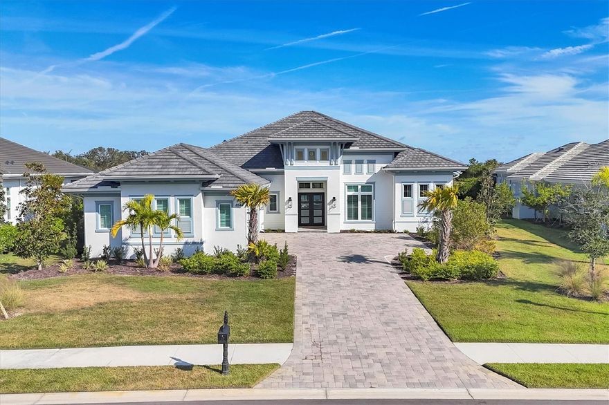 Short Sale. Gorgeous! Stunning! This Beautiful 'Stock' Built, 4 Bedrooms & 5 Washrooms 'Lake Club' Home is Located On One Of The Best Lots (18,914 Sq. Ft) With Backyard Privacy & Amazing Pond/Lake Views! No Homes Behind! Rare 'Glenmore' Floor Plan. 3491 Sq. Ft. Living Area, 5374 Sq. Ft. Total Area. An Open Concept Layout, Soaring High Ceilings and Top Of The Line Custom Finishes. Huge Kitchen Island, Quartz Counters, Jenn Air Appliances, Walk-In Pantry. Luxurious Primary Bedroom With Walk-Out To Pool, Dual Washroom Vanities, Soaking Tub And Spa Like Walk-In Shower. His & Hers Walk-In Closets. 3 Additional Bedrooms All With Ensuite Washrooms. Bright Office With French Doors. A Spacious 3 Car Garage With Plenty Of Storage Space. Resort Like Backyard, Perfect For Entertaining! Heated Salt Water Pool, Spa, Tanning Ledge, Fireplace, Outdoor Kitchen W/Grill, Bar Fridge & Island. A Very Private Lot Featuring Pond/Lake Views. The 'Lake Club' Is Located Within A Few Miles From University Town Center, Lakewood Ranch Main Street, Waterside Place, Restaurants and Shops. The Community Amenities Feature A Grand Clubhouse, Two Resort Style Heated Pools, Restaurant & Bar, Fitness Center, Tennis & Pickleball Courts, Playground, Dog Park, Concierge & Activities Director, Fully Gated Community With Gatehouse Guard. See Virtual Tour With Video, 3D Tour & Photos.