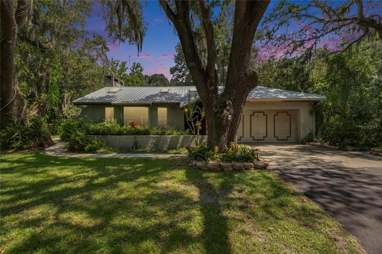 Tucked away on 5.6 acres of beautifully landscaped and fully fenced land, this 3-bedroom, 2-bathroom ranch-style home offers 1,856 square feet of heated living space and the peace of true seclusion. A long paved driveway leads you through mature trees and into your own private oasis.
Enjoy quiet country living with modern comforts including a refreshing in-ground pool, a cozy wood-burning fireplace, and a durable metal roof. The spacious layout includes a bright living area, well-appointed kitchen, and comfortable bedrooms. Outdoors, you'll find a dog run, plenty of room for gardening or hobbies, and space to roam.
Located in the county with no HOA, this property offers the freedom and privacy you’ve been searching for—perfect for nature lovers, homesteaders, or anyone craving more space.