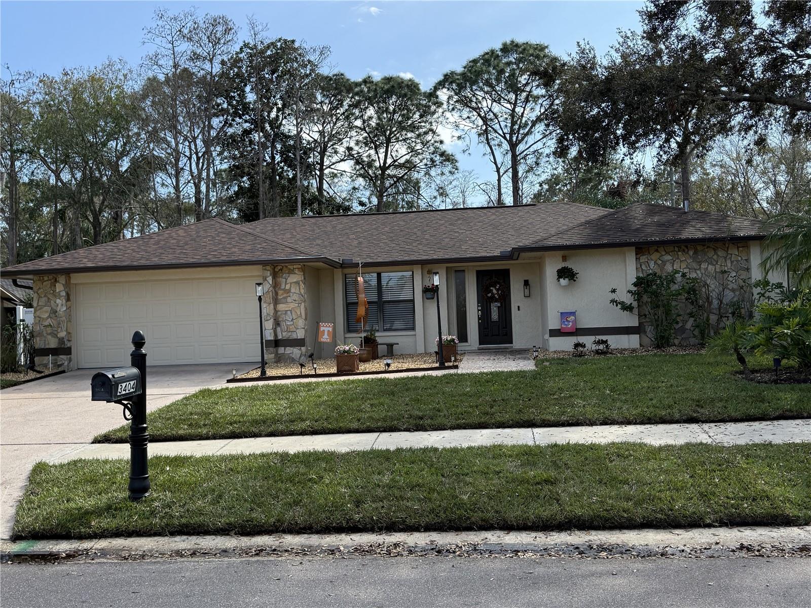 This move in ready ranch home is located in the highly desirable Tarpon Woods neighborhood of Palm Harbor and has had many recent upgrades and renovations: Double paned windows, sprinkler system, new A/C, pool pump, new roof, external painting, remodeled entryway, front yard re-sodded, re-landscaped backyard, motion cameras, smart front doorbell, kitchen appliances, full gutters & leaf filter system, new laundry sink, all lighting update, lanai re-sealed, total new main bathroom features 2 vanities, oversized tub, multi head shower, & a life changing bidet. Kitchen has all stainless steel appliances, garbage disposal, granite countertops, a pantry, and wood cabinets overlooking covered lanai and screened heated saltwater pool & spa. Primary bedroom has walk-in closet and slider access to pool. Two good sized other bedrooms/office with a shared bathroom and a third bathroom leading into the pool area. Third bathroom and screened in porch have built-in doggy doors. This home is ideally located near local restaurants, shopping, banks, Honeymoon Island State Park and beach which includes a dog beach. Only a 30 minute drive to Tampa International Airport. Home for sale either empty at $714,000 or As is with full furnishings and all contents at $734,000.
