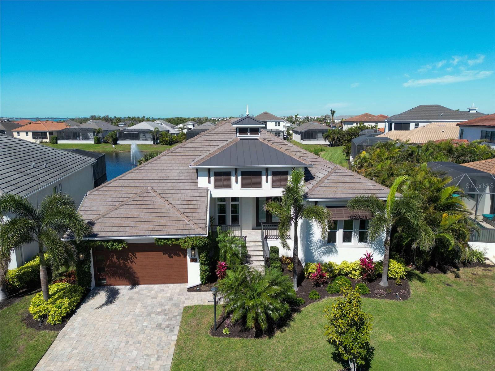 NEW PRICE IMPROVEMENT, OFFERING EXCEPTIONAL VALUE FOR THIS STUNNING PROPERTY! SELLER'S WILL CONSIDER A QUICK CLOSE! Legends Bay gated community offers the perfect blend of luxury and natural beauty, on Sarasota Bay with a clubhouse overlooking the lake, a resort-style pool, and a scenic boardwalk leading to a fishing pier on Sarasota Bay. This sought-after community is just minutes from beautiful beaches, downtown Sarasota, and IMG Academy—an ideal location, especially for IMG families who appreciate both comfort and convenience.
This stunning home is filled with high-end upgrades, starting with a custom real wood walk-in closet in the master suite and a thoughtfully designed laundry room for both style and functionality. Elegant shiplap tray ceilings add warmth and character throughout the Great Room, dining room, master suite, a large den, and a huge bonus room, while ceiling fans ensure comfort in every space, from the main living areas to the lanai.
Designed for entertaining, the outdoor summer kitchen is fully equipped with a premium grill, refrigerator, hot and cold water sink, garbage disposal, and polished granite countertops. Overlooking the lake, the saltwater pool features a relaxing bubbler and full automation, creating a private backyard retreat where you can take in breathtaking sunsets and the beauty of Florida’s wildlife.
Peace of mind comes an alarm system, a whole-home natural gas generator with remote monitoring, Category 5-rated hurricane protection, motorized roll-down screens for the lanai, and reinforced shutters for the bonus room’s windows and doors, in addition to Hurricane-Rated windows, sliders and doors throughout, and hurricane rated garage door. Additional luxury touches include motorized blinds, a tankless water heater, designer lighting, custom shutters, built-in matching counter tops. Over $100,000 in additional upgrades!
More than just a home, this is a lifestyle—where luxury, convenience, and security come together in one of the area’s most desirable communities. Don’t miss your chance to experience it for yourself. Contact us today for a private tour. All dimensions are approximations and should be verified by Buyer.