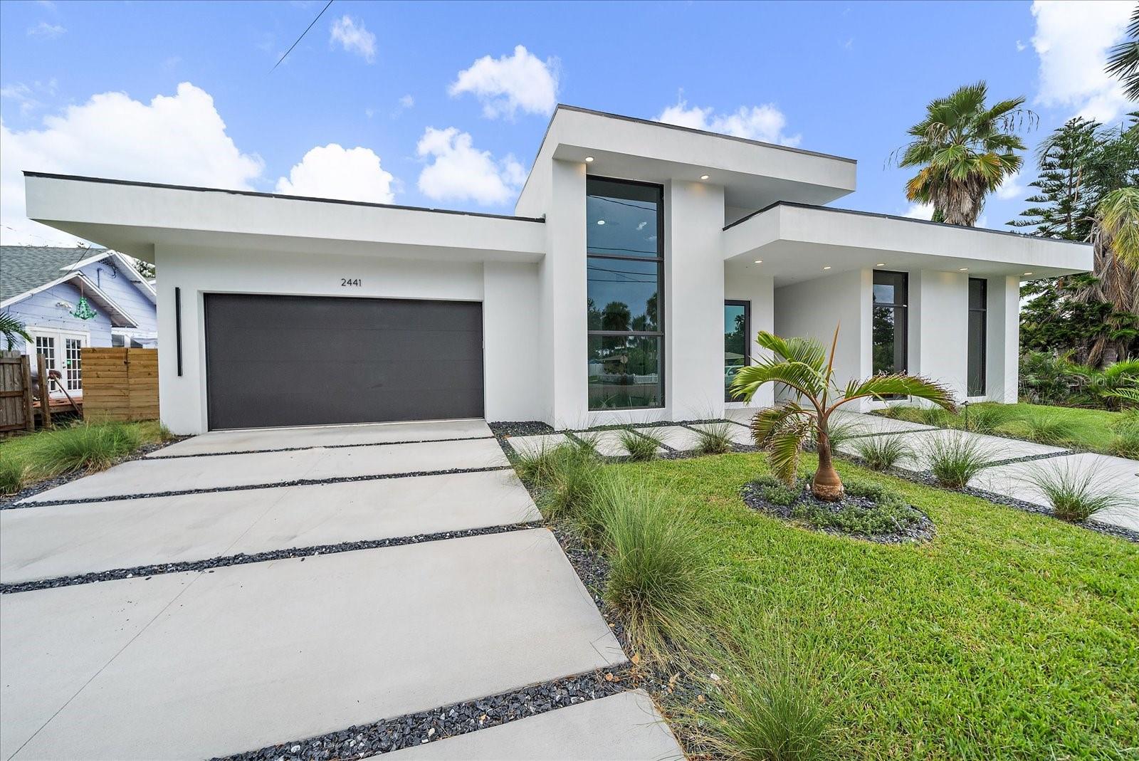 One or more photo(s) has been virtually staged. Vibrant, sophisticated, and undeniably cool, this brand-new 2025 custom contemporary Sarasota pool home is more than just a residence—it’s a vibe. Designed for those who appreciate modern luxury with effortless functionality, this striking new construction residence offers a rare blend of sleek architectural design, spacious interiors, and resort-style outdoor living. Perfectly positioned just minutes from downtown Sarasota, Siesta Key, and the Gulf beaches, it captures the essence of Florida’s coastal lifestyle with a bold, fresh twist.
Set on an expansive 85’ x 117’ lot, the property delivers privacy and serenity behind its fully fenced grounds. The backyard retreat is anchored by a heated pool and spa with a sun shelf water feature, framed by lush greenery and a small shaded alcove that invites both intimate evenings and lively gatherings. North-facing orientation ensures the perfect balance of sunlight without excessive heat, while the all-concrete block construction, impact-rated glass, and durable roof promise long-lasting strength and efficiency.
Inside of this 1-story home, soaring 9 foot ++ ceilings and walls of glass flood the home with natural light, illuminating the seamless flow of large-format porcelain tile flooring. The open-concept living and dining spaces merge effortlessly with a chef’s dream kitchen, complete with a dramatic waterfall island, Monogram stainless steel appliances, induction cooktop, InstaHot water feature, and custom soft-close cabinetry. Every surface, every finish, and every detail is brand-new—designed to impress yet built for comfort.
With 4 bedrooms, 3.5 baths, including three ensuites, the floor plan of 2,726sf under air is ideal for multi-generational living, extended guests, or seasonal visitors. The primary suite serves as a private sanctuary with dual walk-in closets and a spa-style bath featuring dual vanities, LED-lit mirrors, and a freestanding soaking tub encased within a glass shower retreat.
Secondary suites each offer their own sense of luxury and privacy, while a striking front-facing bedroom with towering windows makes a stunning architectural statement.
Practicality enhances the elegance with low insurance costs, Flood Zone X designation (no flood insurance required), and no HOA or CDD restrictions. The home’s flexible leasing rules allow monthly rentals up to 12 times per year, making it an Airbnb-ready investment as well as a luxurious personal residence. Nestled in the highly sought-after Southside Elementary School district, it offers not only modern design and efficiency but also one of Sarasota’s most coveted locations.
Every element of this home has been carefully curated to deliver a lifestyle that is sophisticated, low-maintenance, and distinctly Sarasota. It is a statement piece of modern architecture paired with all the comforts of a brand-new build, offering its very first owner the rare opportunity to live in a home that is stylish, efficient, and completely turnkey.
This is Sarasota luxury living redefined—schedule your private tour today and feel the energy of this one-of-a-kind home. Seller (and creative) financing available too so inquire with the agent!