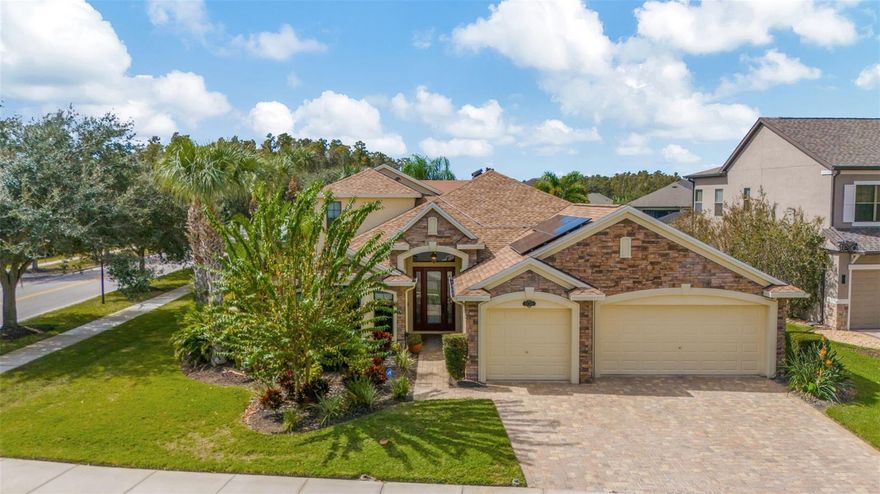 One or more photo(s) has been virtually staged. Elegance and craftsmanship define this stunning corner-lot pool home with pond views and access to community amenities. Wood-look tile flooring, decorative niches, custom window shades, Tiffany-style lighting, French doors to the den, and remote-controlled ceiling fans set the tone throughout.
The gourmet kitchen is thoughtful and stylish. Featuring a tiled backsplash, window display cabinetry, breakfast bar, pull-out trash bin, walk-in pantry, and an office nook, all complemented by stainless steel appliances and whole-home pull-out drawer systems.
The primary suite offers a serene retreat with a sitting area, lanai access, and a spa-style bath with a jacuzzi tub, walk-in shower, and double vanities. The custom cedar-lined walk-in closet is truly impressive, with hidden jewelry storage, valets, display windows, hamper bins, and plenty of adjustable shelving.
Upstairs, a loft with wet bar, mini fridge, and half bath provides versatile living space for entertaining or relaxing.
Outdoors, enjoy a heated saltwater pool with nebulous lighting, pavers in the pool and grill areas, and owned solar for the home and pool. Additional features include a 3-car garage, water softener and filtration system with sink dispenser, alarm system, two HVAC systems with UV lights, and a new roof (2023).
With a low HOA in a highly desirable neighborhood, this move-in-ready luxury home truly has it all with so many upgrades and features you have to view for yourself.