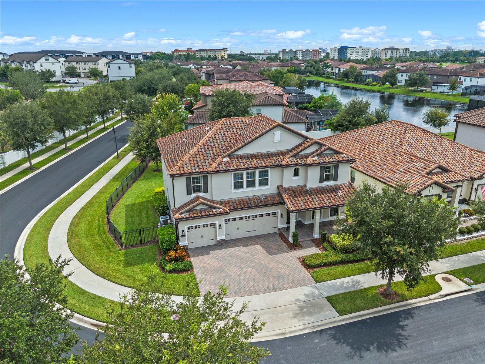 Nestled within the exclusive gated community of Ruby Lake, this stunning corner-lot home offers the perfect blend of modern luxury and energy efficiency. Featuring 5 bedrooms, 4 bathrooms, and 3273 square feet of living space, this residence combines elegance with everyday comfort. This convenient layout begins with a formal dining room that connects seamlessly to the gourmet kitchen through a spacious butler’s pantry, complete with a built-in wine fridge. At the heart of the home, the open-concept kitchen and great room are designed for both daily living and entertaining, showcasing ceiling-height cabinetry, quartz countertops, a stylish backsplash, and GE® stainless steel appliances—including a built-in microwave and wall oven, natural gas cooktop with vented hood, and more. A private guest suite with a full bath completes the first floor, where elegant porcelain tile flows throughout the main living areas. Upstairs, you will find a spacious primary bedroom, a generous loft, laundry room, and three additional bedrooms with luxury vinyl flooring and three full baths. The owner’s suite is a private retreat with serene rear-facing windows, a spa-inspired bath featuring dual vanities, oversized shower with semi-frameless enclosure, and a spacious walk-in closet. Another upstairs bedroom also includes its own en-suite bath.Outdoors, enjoy a spacious fenced backyard with plenty of room to entertain or play. Step outside and take in the partial pond view. A 3-car garage provides ample space for parking and storage. Water softener and tankless water heater. Ruby Lake offers exceptional resort-style amenities, including a private boat dock, community pool with splash pad, clubhouse with fitness center, tennis and pickleball courts, fire pit, and more. Ideally located near A-rated schools, premium shopping, top dining, and just minutes from major highways, community parks, and world-renowned attractions—Walt Disney World and Universal Studios are less than 20 minutes away. Experience the very best of Central Florida living—schedule your private tour today!