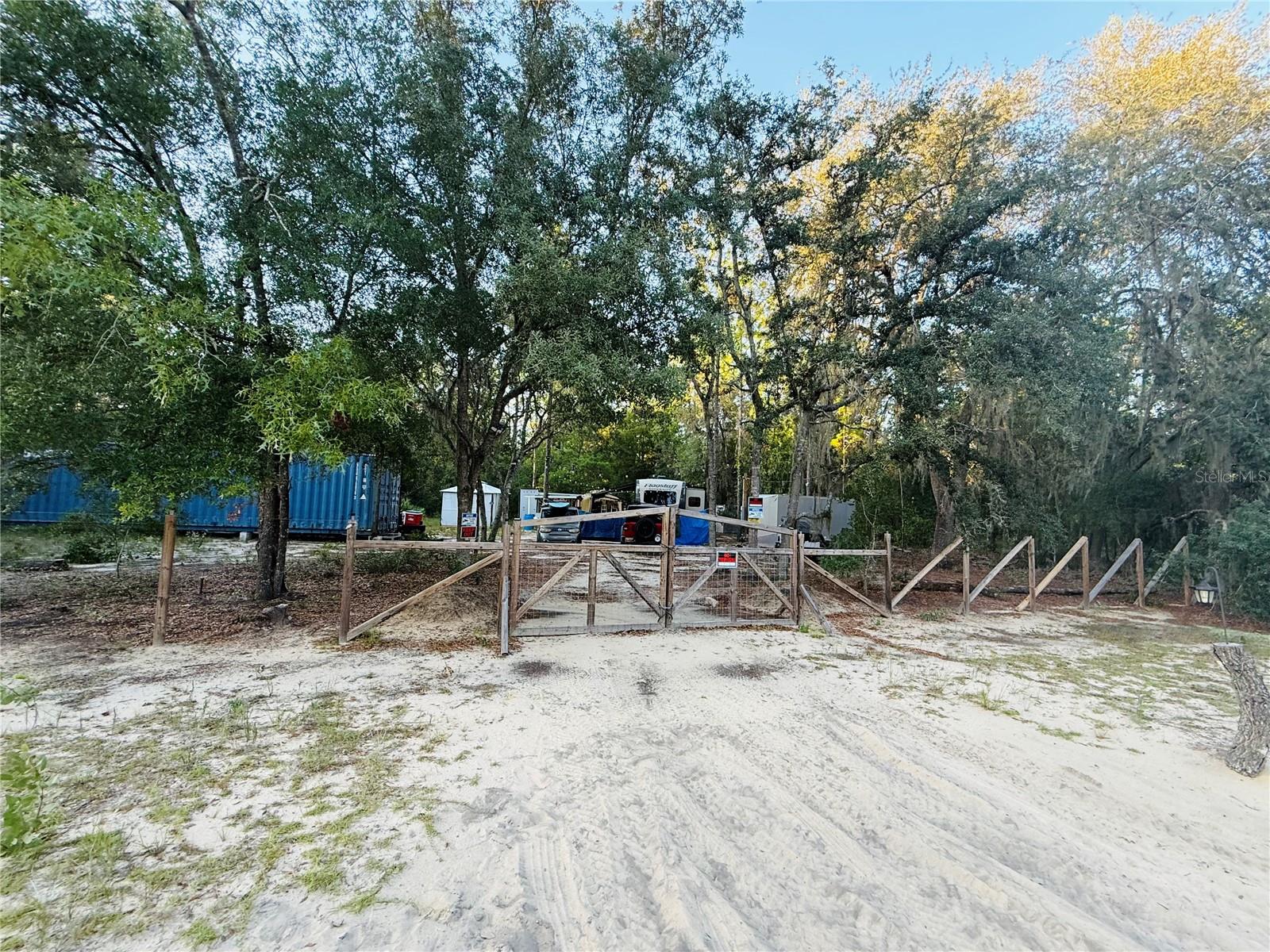 Tucked away in the peaceful and natural setting of Interlachen Lake Estates, this 0.40-acre fully cleared and gated lot offers the perfect opportunity to live simply and affordably while being surrounded by nature. Permitted for RV connection and move-in ready, the property includes a heavy-duty metal gate, cleared driveway, 40ft x 9ft shipping container, 250-gallon water tank tote, solar panel (buyer to permit), electrical box, mailbox, 12x20 carport, and an outdoor shell for a toilet or shower. It’s the ideal setup for off-grid or minimalist living. Enjoy the quiet of your own space while still being just 10 minutes from lakes and parks offering fishing, hiking, camping, boating, and water sports. You'll also be 30 minutes from Palatka Golf Course, 45 minutes to Florida Springs, 1 hour to the beaches, and 2 hours to Disney and Universal Studios. The area is known for its small-town charm, welcoming atmosphere, and laid-back lifestyle—perfect for those who want to connect with nature and escape the hustle and bustle. A 2022 26RBLS Flagstaff Super Lite RV with generator is also available—just ask. Everything you need is here for peaceful, affordable living or the perfect weekend getaway.