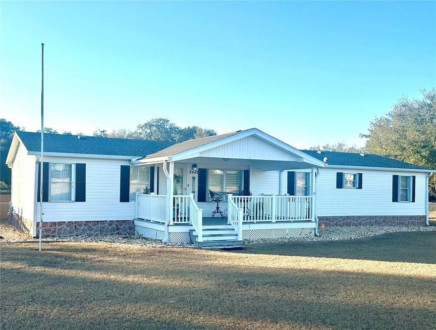 Step into your very own tropical oasis! This backyard is designed for entertaining and unforgettable social gatherings. Enjoy evenings at the custom tiki-bar, and unwind after a long day in the hot tub with swim spa. Inside you will find a spacious layout with seamless flow between the living and entertaining areas. This spacious and well maintained 3-bedroom, 2-bath  manufactured home perfectly blends comfort, style, and functionality — all just minutes from everything you need!

Situated on a large, level lot, this property immediately welcomes you with a charming covered front porch — the perfect place to enjoy your morning coffee or relax in the evenings. Step inside and you’ll be impressed by the expansive open floorplan featuring two separate living areas, giving you incredible flexibility for entertaining, and additional family space.

The heart of the home is the stunning island kitchen, designed with both beauty and practicality in mind. You’ll love the solid surface countertops, abundant cabinetry, and spacious layout that flows seamlessly into the main living area — ideal for hosting gatherings or everyday living. The neutral color palette throughout creates a bright, modern feel, while no carpeting means easy maintenance and a clean, cohesive look. Elegant plantation shutters throughout add charm, privacy, and a timeless touch to every room.

The split bedroom layout provides added privacy. The primary suite offers a generous space and natural light leading in to a custom designed ensuite bathroom that will absolutely impress!

The iOUTDOOR entertaining space features a Tiki bar that’s ready for weekend cookouts, game-day parties, or evening get-togethers. After entertaining, unwind in the beautiful swim spa and enjoy your own private oasis. This outdoor area truly sets this property apart.

For the hobbyist or anyone needing serious storage space, this property is a handyman’s or car collectors dream come true! With a two car garage and additional oversized storage building with fenced yard and ample room to park all your toys — boats, RVs, golf carts, or recreational vehicles — there’s space for it all without restrictions of a HOA. 

Conveniently located just 2 minutes from The Villages and Stonecrest, Spruce Creek South golf courses,  you’ll enjoy easy access to golf, shopping, dining, entertainment, and medical facilities while still having the freedom of your own spacious property.
Homes with this combination of location, space, upgrades, and entertaining features are hard to find. Don’t pass this one by — schedule your private showing today!