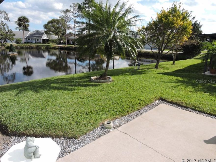 Waterfront golf villa is ready to move in! Enjoy cool breezes as you relax on pond-front patio, as well as sunrises over the water. Great water views from spacious rear family room with central heat/A/C. Exterior is maintenance free with vinyl siding, 2005 architectural shingle roof. Large carport and storage closet, A/C system new June 2014, Plantation shutters with top-bottom split and new insulated windows in main house. New bay window in living room, vaulted ceiling, partially updated bathrooms. Walk to heated community pool, available by optional membership. Nestled between 2 golf courses, central location - close to everything, minutes to beach. Low HOA annual dues provide sprinkler system and water to it, termite bond and common area maintenance. Furnishings available outside closing, by inventory. ;Water: City