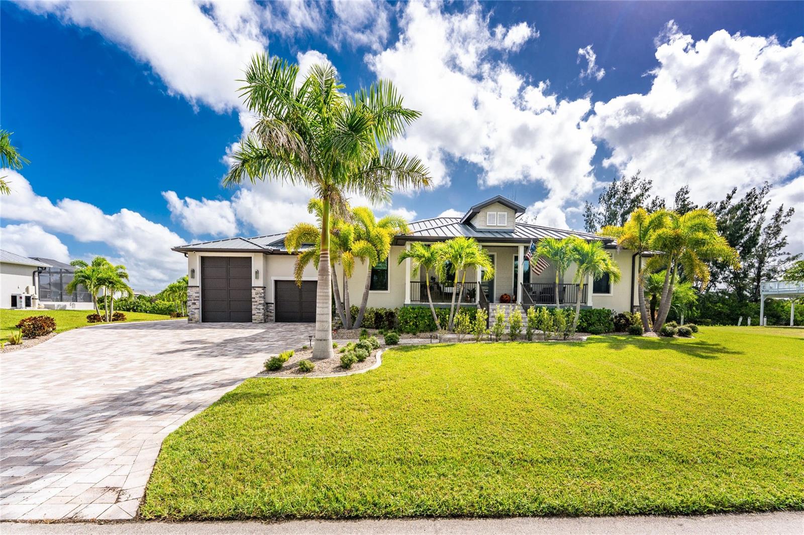 Spectacular waterfront custom home on TWO LOTS - the owner is a custom builder and this home offers stunning design features throughout. This light and bright home offers 3 Bedrooms Plus Office, 3 full bathrooms and attached 6+ Car Garage. There are two garage doors - one is 12 feet high, the other 8 feet high. There is an open and split bedroom floor plan with Great Room, separate Dining Room, well appointed Kitchen, Inside Laundry. The Great Room has coffered ceilings and oversized sliding glass doors that lead to the lanai. The Great Room opens to the Dining Room and Kitchen. The Kitchen features quartz counters, wood cabinets with crown molding, tile backsplash, breakfast bar that seats four, dining area and stainless appliances. Appliances include built in microwave, built in oven, cooktop, dishwasher and French door refrigerator. The Inside Laundry offers a front loading washer and dryer, white cabinets with lots of storage space and sink. The spacious Master Bedroom suite features oversized sliding glass doors to the lanai, transom windows, huge walk in closet and private bathroom with walk in shower with stunning tile work, bathtub, his and hers sinks, wood cabinets and quartz counters. There are two generous sized guest bedrooms and two guest bathrooms, one with a walk in shower, the other with a tub/shower combo and one is a Pool Bath. Sliding glass doors lead to the screened lanai with outdoor kitchen (two grills- one is flat griddle), heated inground saltwater pool with attached inground spa, waterfall and Pentair control system, large covered area and plenty of deck for sunbathing. Continue to the waterfront with **140 foot concrete seawall **, 35 foot trex dock and 18x25 boathouse, 10,000 lb boat lift with remote. Boating access to Charlotte Harbor and on to the Gulf of Mexico. Other features include a front porch, high quality metal roof, whole house generator, irrigation system paver driveway and walkway, 8 foot doors,wood look tile floors throughout the house. The front porch swing conveys with the house. This home is 5 minutes to Golf and historic downtown Punta Gorda shopping, dining, medical care, waterfront parks, walking and biking paths, art galleries, Charlotte Harbor Event Center, Fishermen's Village, weekend farmer and artisan markets, weekend events and much more.