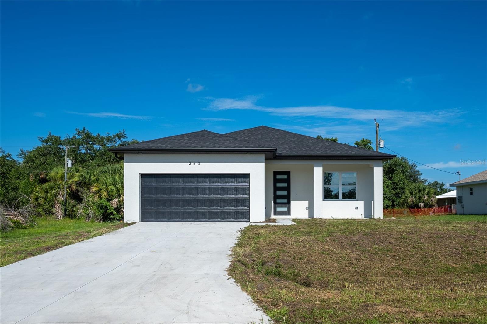 Discover this exquisite brand-new construction home in the desirable Port Charlotte area, where convenience and comfort meet. Located just 5 to 10 minutes from top shopping centers, popular dining spots, and a variety of recreational options, this home offers the perfect balance of relaxation and accessibility. When you're ready to enjoy the Florida sunshine, you're just a short drive from pristine beaches like Englewood Beach, Manasota Key, and Boca Grande. Inside, you'll find a modern open layout with a spacious lanai, perfect for outdoor living. The bathrooms are elegantly finished with beautiful tile, while the kitchen features sleek quartz countertops and all-new, high-end appliances. Additional highlights include a brand-new roof and HVAC system, impact-resistant windows, and door sh utters for added safety and durability. This home is a true gem, offering quality craftsmanship and a prime location – ready for you to move in and make it your own!