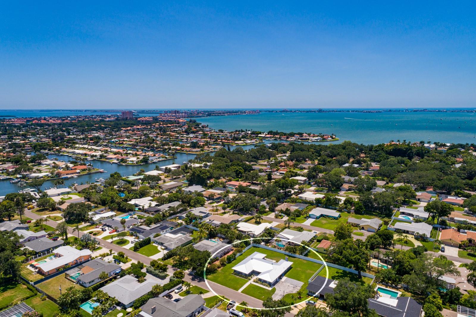 One or more photo(s) has been virtually staged. BEAUTY in BROADWATER ~ FALL in LOVE with this EXTRAORDINARY BEAUTIFUL .45 ACRES one-story EXECUTIVE HOME in the coveted BROADWATER Community of St. Petersburg. This meticulously renovated architectural masterpiece is 5 bedrooms and 3 and a half bathrooms. This remarkable residence showcases the finest materials, features, and finishes that epitomize sophistication and elegance. The seamless open concept layout harmoniously integrates all of the living spaces. This GORGEOUS RARE 5 bedrooms and 3 and a half bathrooms Executive Home boasts 3,028 sq ft of meticulously designed living space on a 19,410 sq ft lot. This residence provides a well-thought-out floor plan. Pull up to LUSCIOUS landscape and BEAUTIFUL curb appeal. As you enter the UNIQUE front doors, you will LOVE the abundance of natural light, continuous seamless ceramic tile flooring throughout the home, handcrafted millwork, and sliding doors that open up to the BEAUTIFUL OUTDOOR PARADISE with HUGE COVERED lanai and outdoor shower. YOU will be AMAZED by the CUSTOM features in this home. This perfect family home has everything you could want from a SPACIOUS 2 car epoxy flooring garage, 2 SOLAR fans in attic, crown molding, fold-a-way glass patio sliding doors, designer wood panel accent wall, BARN DOORS, chalkboard wall, a spacious interior laundry room, wood burning fireplace, outlets in closets and cabinets, metal roof (2019), open floor plan, and much more! The Executive Home offers a large primary suite with a SPACIOUS walk-in closet, an en-suite bathroom with large vanity and dual sinks, curbless walk-in shower, and private entry to the HUGE lanai. This home is open and inviting ~ allowing the chef to be part of the activity. YOU WILL LOVE COOKING in the BEAUTIFUL OPEN CUSTOM kitchen, which is a chef's dream! It is very spacious with a HUGE KITCHEN ISLAND, beautiful cabinetry, quartz countertops, stainless appliances, double convection oven, a wine refrigerator, under cabinet lighting, and 2 separate sinks. The kitchen opens up to a bright cozy family room with a fireplace and sliding doors that open up to the GORGEOUS lanai and HUGE backyard. The large private lanai is perfect for entertaining. LOVE the spacious two car garage and ample driveway parking. Every aspect of this home has been meticulously designed with top-of-the-line finishes and is being sold turnkey! Every detail of this home reflects unparalleled craftsmanship and is made for those who appreciate the finer things in life. Broadwater is one of the BEST locations offering quick access to all the BEACHES, DOWNTOWN St. Petersburg, airports, interstates, shopping, and restaurants. LOVE this extraordinary residence which offers a perfect harmony of urban sophistication, natural beauty, and unparalleled blend of elegance and comfort! Every aspect of this luxurious architectural masterpiece has been thoughtfully curated to exceed the expectations of the most discerning individuals. YOU MUST SEE this little bit of Florida Paradise in this COASTAL COMMUNITY! **THIS HOME HAS NEVER FLOODED** ~ PRICED TO SELL ~