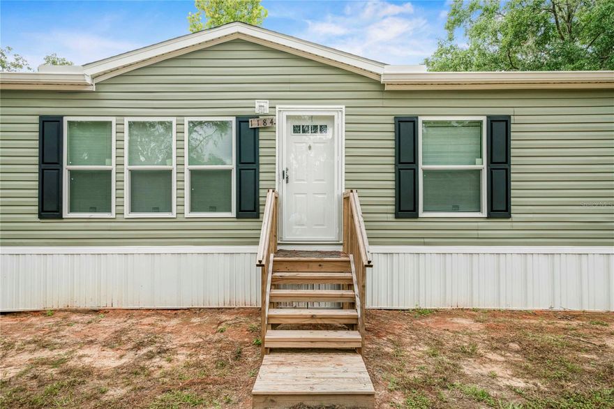 Brand-new 2024 Live Oak manufactured home with 4BR/2BA on a spacious 1.25-acre lot—no HOA restrictions! This modern home offers exceptional value with a thoughtfully designed open floor plan and highly desirable split bedroom layout.
The heart of the home features a stunning kitchen with a large island complete with sink, generous dining bar seating, and abundant cabinet storage. The kitchen seamlessly flows into two separate living areas, providing versatile spaces perfect for entertaining guests or enjoying quiet evenings at home.
The smart split floor plan places the primary suite on one end of the home, featuring a spacious walk-in closet and relaxing soaking tub. The three additional bedrooms are located on the opposite side, creating excellent separation and a functional layout ideal for family, guests, or home office space.
Country living features include:

Pre-installed chicken run and starter coop ready for your flock
Wide-open 1.25-acre lot with endless possibilities
Room for future barn, workshop, garden, pool, or additional outbuildings
No HOA means freedom to customize your property
Modern construction with multiple access points throughout the home for excellent flow

This property perfectly balances modern amenities with the freedom of country living. Whether you're looking to raise chickens, start a garden, or simply enjoy wide-open spaces, this home is move-in ready and waiting for your personal touch. Schedule your private showing today!