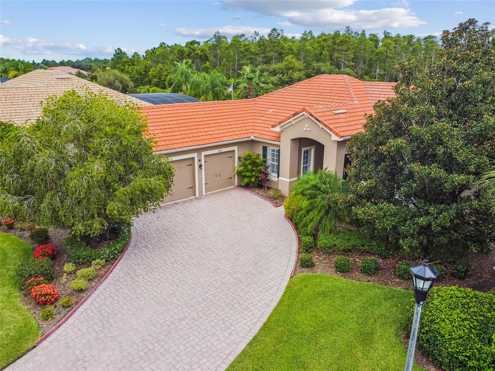 Welcome to this spacious and well-appointed Sevilla model, offering 3 bedrooms, 3 full bathrooms, a versatile DEN, and a rare 3-CAR GARAGE.**See the FULL LENGTH 3D MATTERPORT VIDEO on Tour Link 1. ** Located on a beautifully landscaped OVERSIZED corner lot (.35 acres), in Portofino Estates, this home backs to conservation, providing privacy and serene views. Volume ceilings, CROWN MOLDING, and lots of natural light create a bright, open feel throughout. The OPEN-CONCEPT kitchen flows into the main living area and features STAINLESS STEEL APPLIANCES, tall cabinetry, CORIAN COUNTERS, a stylish backsplash, a breakfast bar, and plenty of storage. The adjacent dining area boasts a charming BAY WINDOW BUMP-OUT and sliding glass doors that lead to the lanai—ideal for indoor-outdoor living and entertaining. Ceramic tile flooring runs throughout the main living areas, while the den includes rich HARDWOOD FLOORS and double doors—perfect as a home office, hobby room, or optional fourth bedroom. The spacious PRIMARY SUITE features cozy carpet, a TRAY CEILING, a large walk-in closet, and a private ENSUITE bath with DUAL SINKS, a soaking tub, a TILED WALK-IN SHOWER, and a generous linen closet. Sliding doors open directly to the PRIVATE LANAI, perfect for enjoying some quiet time outside. Two additional guest bedrooms each have access to their own full baths, providing comfort and privacy for guests. The EXTENDED, SCREENED lanai features a solid roof, and serene views of the conservation area and mature trees—perfect for outdoor enjoyment year-round. This home also features thoughtful upgrades throughout, including PLANTATION SHUTTERS, updated lighting fixtures, and ceiling fans in every room for added comfort. The laundry room offers extra cabinetry for storage, and the WASHER and DRYER are INCLUDED with the sale. TILE ROOF chemically cleaned July 2025 for ongoing maintenance and upkeep. Don’t miss this exceptional home located in a vibrant 55+ community, offering a wealth of amenities, social activities, and an active lifestyle designed for today’s discerning buyer. Solivita's amenities include: - a manicured SOFTBALL diamond & field - 36 holes of CHAMPIONSHIP GOLF that can be played by joining the Stonegate Golf Club or paying as you go - 2 STATE of the Art AMENITY centers with updated exercise equipment, yoga studio & meeting rooms - 3 restaurants - 14 HEATED POOLS - 17 PICKLEBALL courts - 9 TENNIS courts - 4 BOCCE BALL courts - 4 SHUFFLEBOARD courts - 3 HORSESHOE pits - a BILLIARDS room - miles of bike paths - 2 DOG PARKS (Small & Large Dogs) - Corn Hole - Tot Lot PLAYGROUND - COMMUNITY GARDEN - over 250 resident clubs. The HOA: - maintains the LANDSCAPING & IRRIGATION systems in the common areas as well as at individual homesites - maintains the roads throughout the community - PROVIDES SECURITY with gate guards and mobile patrols including the Polk County Sheriff - allows AUTOMATED GATE ACCESS for residents via license plate readers - provides residents with Fiber Optic Internet & TV service.***Poinciana Lakes Plaza is a MAJOR NEW SHOPPING CENTER that opened directly across from the Solivita Main Gate in Summer of 2024. It features Sprouts Grocery, TJ MAXX, Ross, Burlington, Rack Room Shoes, 5 Below, Ulta, Outback, First Watch, 5 Guys, Urgent Care, Dentist, TD Bank, Petco & Hair Cuttery PLUS MORE TO COME.***