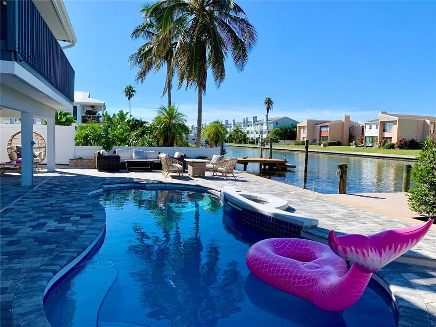 Exceptional Waterfront Property – Fully Furnished & Turnkey



Rarely available waterfront home with beautiful water views from both the front and back. Fully furnished and professionally maintained with a strong rental history. Located on a quiet dead-end street just minutes from the beach, dining, shopping, and local attractions.



Situated on a saltwater canal, the property includes a heated pool, private dock with above- and underwater lighting, recently dredged boat access, an updated seawall, and a new whole-home Generac generator.



Inside, a 27-ft family room features a fireplace and sliding doors opening to a large balcony overlooking the water. The remodeled chef’s kitchen includes a 60” built-in refrigerator, 48” dual-fuel range with double ovens, double sinks, granite countertops, marble backsplash, and a massive 13’ x 5.5’ island with seating for seven. The kitchen flows into the dining and family areas, all with views of the Intracoastal.



The primary suite includes a walk-in closet, double vanity with granite, tiled walk-in shower with glass enclosure, dual shower heads, jacuzzi tub, and a decorative stained-glass window. The guest bathroom is also fully updated.



The lower level features a spacious 24’ x 16’ room with sliding doors that open to the pool and lanai area, finished with travertine pavers and plenty of space for outdoor entertaining.



Major updates include: a brand-new roof, new natural gas pool heater, new tankless gas water heater, updated seawall, new generator, and more. Too many upgrades to list—this turnkey property is a must-see!