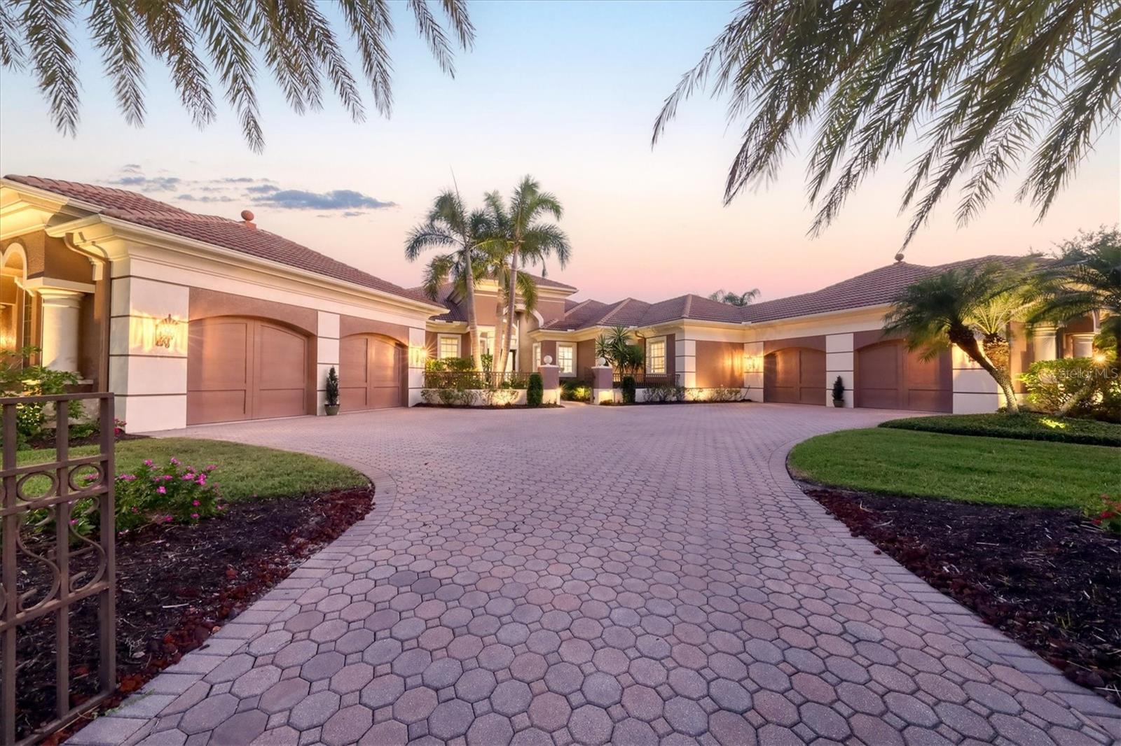 Grandeur is just one of many adjectives to describe this beautiful custom built Arthur Rutenberg sprawling ESTATE HOME of almost 5500 SQUARE FEET on a SINGLE LEVEL. Located on an OVERSIZED PRIVATE PRESERVE LOT of 3/4 ACRE in one of the most desirable sections of Lakewood Ranch Country Club called Palmer’s Creek. Your trip home all begins as you enter Palmer’s Creek Terrace a serene and beautifully treelined dead end street. As you drive up to 13302 Palmer’s Creek your home is situated on a lushy landscaped elevated lot at the corner of a cul-de-sac of 2 equally styled homes. Entering your paver driveway, you have a courtyard with split 4 car oversized garages with 2 on each side of the driveway. The gated walkway leading to your oak and glass double doors is landscaped on each side with a beautiful fountain on the left side of the walkway. Opening the double doors, you are now in a 4 bedroom, 4 ½ bath home that is impeccably decorated, while you’re standing in your Foyer with a 16’ ceiling you gaze out through a Living Rm with a cast stone fireplace onto your covered Lanai to a saltwater pool with spa. Adjacent to the Foyer is your Office/Library with expansive built-ins. The center of the home is a wet bar that services the kitchen, family and living rooms and makes entertaining that much easier. The gourmet kitchen has a large island that can accommodate multiple seating, a separate sink in a smaller island all with granite counters, ss appliances include, a 5-burner cooktop, mw, wall oven, warming drawer, counter depth refrig. and Bosch dishwasher. There are wood shelves in a walk-in pantry to keep you fully supplied especially for special occasions that make home perfect for entertaining friends and family. Just 2 of you, the breakfast nook is perfect and has a curved glass window giving full view of lanai and pool area. The Family Rm is within arm’s reach of your kitchen and is 20’x23’. If that is not enough room to entertain your guests slide into your 20’x30’ Bonus Room w/half bath adjacent to Family Rm. It’s a gorgeous day, bring the outside in with the 58’x22’ Courtyard w/fountain that is accessible from both Bonus and Dining Rms. Still need more space, pull back your sliding glass doors off Family and Living Rms to your screened in oversized lanai & pool area. Accommodating your overnight guests is easy, all guest bedrooms are oversized, each with large walk-in closets, 2 of the guest bedrooms are en-suite. As for the Owner’s Suite, it has a separate seating area that can be used as a reading, exercise room or 2nd office. There are 2 walk-in closets with built-ins & the Owner’s Bath is amazing with separate vanities, wading tub, bidet & large walk-in shower. Now that you have entertained your guests head to your Laundry Rm which is proportionally sized to your home, it has ample cabinets, laundry sink and large walk-in storage room. Home is serviced by 3-separate A/C systems, pool has 2 heaters, heat pump to keep your pool at that constant temperature year-round and a gas heater to get the spa heated in minutes both designed to maximize efficiency. There is ample crown molding throughout the home, many feature ceilings that are minimally 10’ or higher plus large baseboards. Palmer’s Creek is a private enclave lined with 29 estate homes that is not a thru street yet conveniently located to the main club house of Lakewood Ranch and two world class 18-hole golf courses within the gates of Country Club West. This is a must see!!!