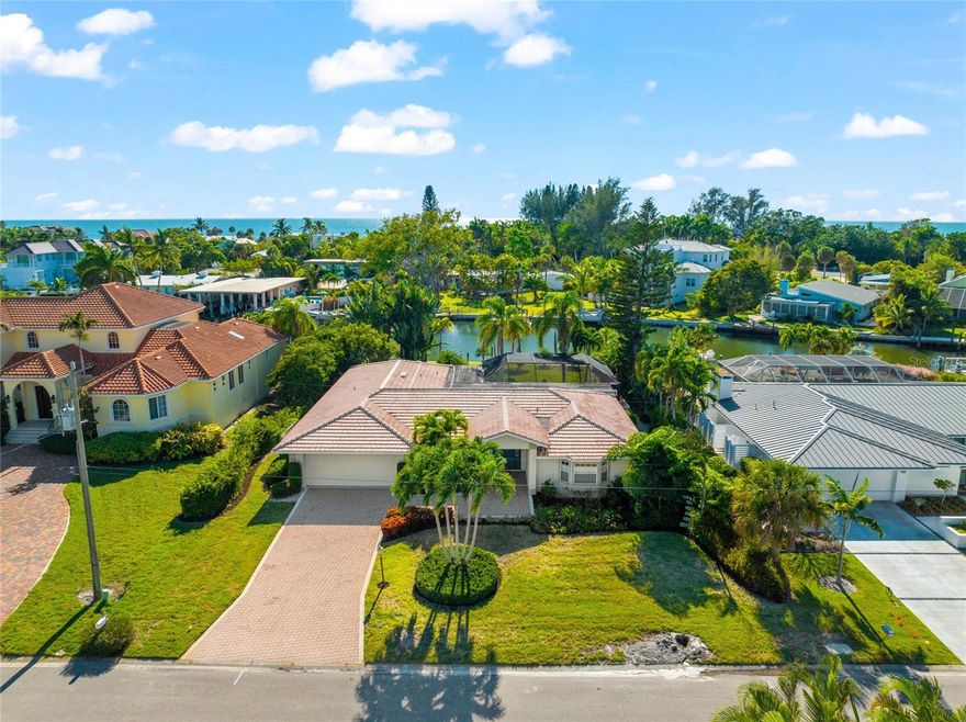 PRICE IMPROVEMENT!   Enjoy island living at its finest in the highly desirable Emerald Harbor community.  This home is built for relaxation and enjoying the Longboat Key lifestyle on a wide deep water canal with ideal boating and kayak access to Sarasota Bay with no bridges.  Take your bike or walk to the deeded beach access and experience sunset and swimming on one of the world-renowned beaches of the Gulf coast.   

Enter this fabulous 2600 sq. ft. 3 Bedroom, 2.5 Bath home and appreciate the seamless flow through the living room, dining room, family room, and kitchen area. Tile floors throughout the main living aeas are ideal for Florida living. This home has everything you need for entertainment plus everyday comfortable living.  The new, thoughtfully planned gourmet kitchen features custom cabinets, a center island with Walnut top, carefully selected quartz counters, all stainless Thermador appliances including double oven and cooktop, wine refrigerator and a pass-through to the lanai.  

The split floor plan provides privacy allowing homeowners to retreat to the spacious Master bedroom with walk-in closet and luxuries including a garden tub, separate shower, dual vanities, indoor and outdoor shower, and access to the pool area.    The guest bedrooms and bath are perfect for visiting family/friends or multi-generational living.

All main rooms leading to the pool area have hurricane/impact doors that pocket behind the wall for open indoor/outdoor living.   It doesn’t get any better than the incredible private and tranquil outdoor sitting areas with around the beautiful paver deck and pool area with new picture window screening.   Follow the paver pathway to an open fire pit and sitting area leading to the new composite dock w/10,000 lb. boat lift

The spacious laundry room is equipped with a second refrigerator, laundry sink, cabinets and incredible storage. It is rare to find a home with so much interior storage.

The premium mid-key location ensures that you are never far away from Longboat Key restaurants and shopping, plus the amenities of St. Armands, Sarasota and Anna Maria Island all the while relishing your peaceful seclusion, in tune to all the surrounding natural beauty Emerald Harbor has to offer.