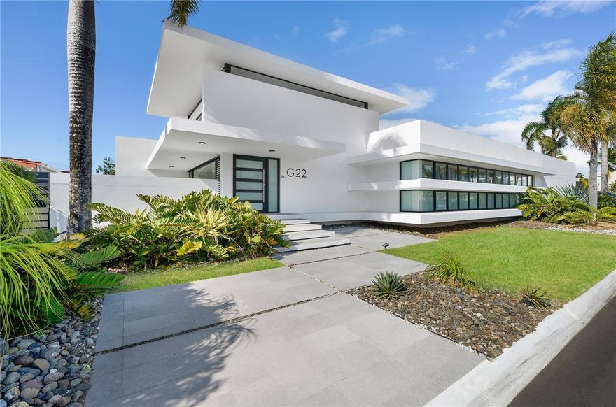 ***SOLD*** Introducing an exceptional single-level residence meticulously renovated in 2023 to the highest standard,  for those with a discerning eye towards contemporary waterfront design. A double-sized corner lot, G22 Granada is positioned within the only gated boating community on the north, Vistamar Marina East, offering spectacular waterfront views and capturing the essence of a dockfront lifestyle. Spanning over approx 2,700 + sq.ft of interior living, this home features 3 magnificently spacious bedrooms, each  with 10+ft high ceilings and thoughtfully designed to provide maximum comfort and privacy. The primary suite is a sanctuary, complete with a modern deco en-suite bath that exudes relaxation. The open-concept living of this ranch style home boasts soaring ceilings, open air floor plan, gourmet kitchen, as well as broad glass frame windows bathing natural light throughout, creating an air of subtle sophistication and tranquility. The gourmet smart kitchen, outfitted with top-of-the-line stainless-steel appliances, and an expansive island facing the properties lush backyard with ample seating, is a chef's dream. Lounge-inspired and incredibly sleek, the living and kitchen areas all fuse into one open loft design. The adjacent dining area, with stunning views of the sunning area and waterway, provides an ideal setting for intimate dinners. The outdoor living space is equally impressive, with a pristine in ground outdoor pool, a private stadium grade tennis court, and a dedicated boat dock, perfect for launching your watercraft, fishing right off of the dock, or taking your canoe out on the canal for a perfect afternoon of leisure. The outdoor kitchen and dining area allow for a seamless transition between indoor and outdoor living, making this space the ultimate in sophisticated entertainment. This exceptional residence offers an unparalleled level of luxury and sophistication, situated within the secure and exclusive community of Vistamar Marina East. This community provides 24-hour security, ensuring a lifestyle of comfort, privacy, and convenience. Indulge in the ultimate waterfront lifestyle in the Caribbean with this turnkey and impeccably renovated, triple-mint residence. This exquisite home, situated in close proximity to San Juan, offers a unique and highly sought-after opportunity nearly impossible to find. Completely self-sufficient in water and energy, this home boasts a full backup generator, water cistern, and solar power system, ensuring uninterrupted power supply and resiliency. Boat slip dimensions are 40 ft. length, 35 ft. width. Monthly HOA: $150.