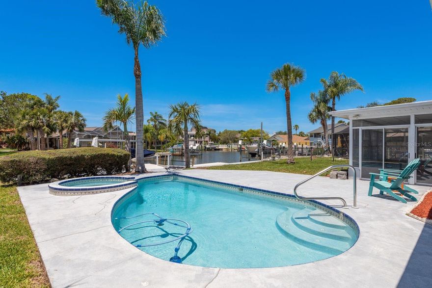 This beautiful, completely renovated, waterfront pool home has everything you want to obtain your perfect tropical lifestyle! Freshly painted and brand-new tile throughout. The all-new kitchen boasts granite counter tops, wood cabinets, stainless-steel appliances, breakfast bar and huge butler’s pantry with wine fridge. Adjacent to the kitchen is the bright and large family room with cathedral ceiling, wood burning fireplace, and views of the waterfront! Large living room with water and pool views. The split floor plan provides lots of privacy. The guest bedrooms are very gracious in size; both are serviced by the newly renovated guest bath with granite countertop and double vanity with vessel sinks. The large primary boasts sliding glass doors leading out to the pool newly renovated bathroom with a double vanity, granite countertop and walk-in shower. The Florida room which leads to the pool and deck is bright and sunny and perfect for entertaining while enjoying the beautiful tropical view of the waterfront. This home sits on almost .25 acre with 80’ of water frontage and has a huge backyard! Enjoy a cool drink while relaxing in the pool or sitting on the fixed dock which has ample room for a patio set. The canal is unobstructed and has easy direct gulf access. 10k lb. boatlift and floating dock. New A/C and new roof! The upscale community of Gulf Harbors Woodlands offers tennis courts, a heated Olympic-size pool, clubhouse with a full kitchen for your special events, and more! There is also an optional private beach you can join for $200 per year! Just a short ride from lively downtown New Port Richey with many restaurants, bars, shops, and Sims Park where you can enjoy one of the many special events and outdoor concerts throughout the year or stroll along the beautiful riverwalk on the Cottee River. First, last, security deposit required. Small pets allowed with owner approval and additional non-refundable pet fee.