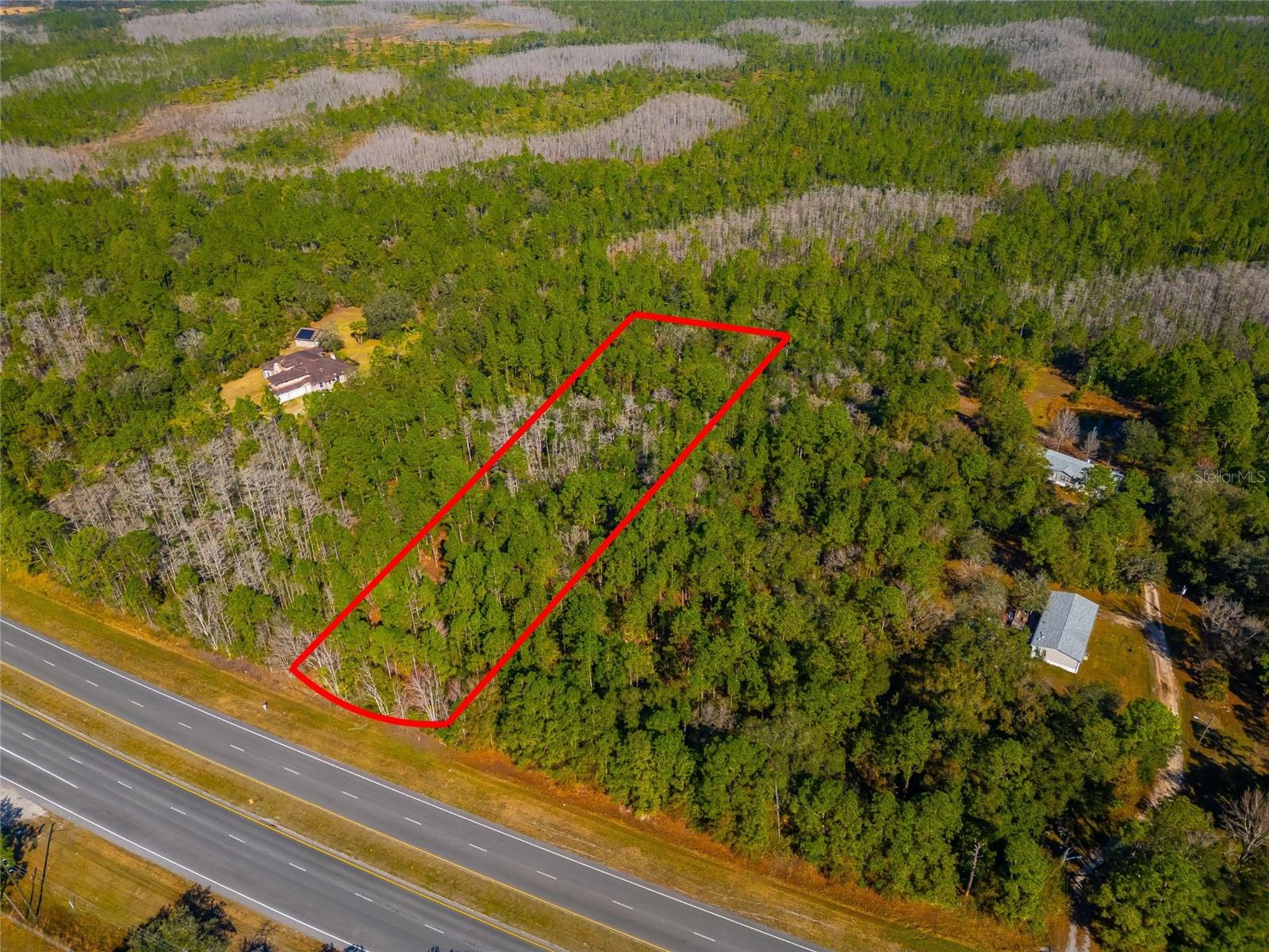 Great Location !!! close to Florida's east coast beaches right off of SR 50. This is a lot with 2+ acres and paved road access to build a future home or you can check with Orange County Building division for rezoning ideas and allowable uses.