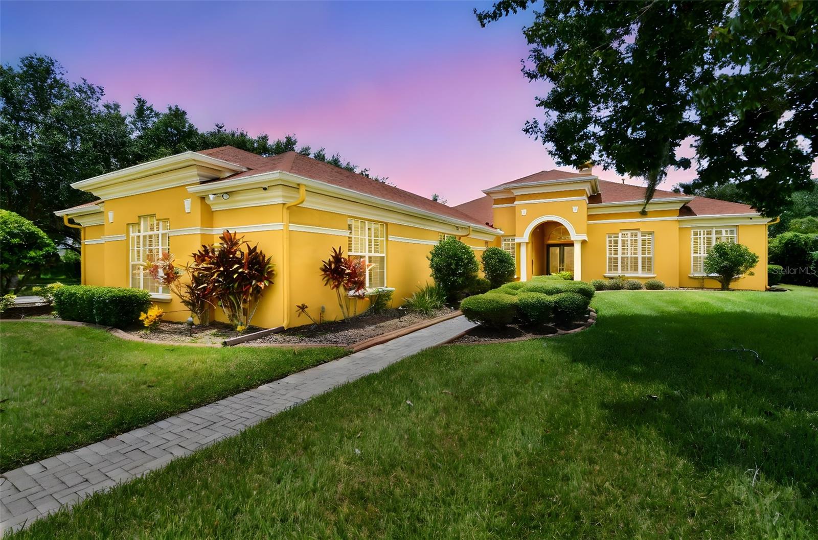 Located within the exclusive gated community of Fish Hawk Trails, which features 24-hour manned security where luxury, privacy, and sophistication blend seamlessly. Situated on over half an acre of beautifully landscaped grounds, this meticulously maintained original owner custom-built Arthur Rutenberg pool and spa home offers 4-bedrooms, 4.5-bathrooms, office, bonus room and spans almost 5,050 square feet of living space across one level, while offering a host of premium features designed for both comfort and style. As you approach, the grandeur of the home is immediately evident, with its stately façade and spacious 4-car side entry garage, sitting on a corner lot in a quiet cul-de-sac. Walk up the paver pathway with its decorative curbing to the leaded double glass front doors. Step inside to discover a thoughtfully designed, bright and open floor plan, freshly repainted in 2022, that exudes warmth and elegance, with its 10-12' tray ceilings and plantation shutters. This beautiful executive home provides peace of mind with a whole home Generac generator, a new roof in 2022, a water softener system as well as the pool being resurfaced and the gas heater replaced in 2022. To your immediate right off the tiled foyer at the front of the home is the office and the huge master suite which spans the entire north side, with pool access from your own personal gym area! Additionally, there are two custom designed walk-in closets, along with a spacious en-suite with dual separate vanities, jetted tub and walk-in shower. Step back out to the family room with hardwood floors, a fireplace, double French doors with built-in blinds along with a tiled counter wet bar. This leads through to the breakfast nook and the gourmet kitchen with granite counters, breakfast bar, double oven, gas stovetop, solid wood cabinetry and a pantry. Adjacent to the kitchen is the spacious living room and this leads on through to the huge bonus/media room with large walk-in storage closet at the rear of the home, along with the convenience of a half bath with direct outdoor access. Relax in your screened gas heated pool and spa and outdoor green space which provides ample room for entertaining, with the additional benefit of an outside sink and built in for cookouts. Next to the kitchen, there is the stately formal dining room with hardwood floors and then this leads down a hallway, where you will have three large en-suite bedrooms, one of these with a single vanity and a tub, while the other two have a single vanity and a walk-in shower. All of these bedrooms have walk-in closets, with two of them having built ins. Continuing on you have the laundry room with plenty of storage cabinetry and a sink, along with access out to the garage with plenty of space for all your vehicles. The home is ideally situated with the nature trails to the side and rear of the home and all the recreational facilities just a two-minute walk away. Fish Hawk Trails benefits from a 24-hour guard, not being in a flood zone, NO CDD and inexpensive HOA, along with having several miles of nature and bike trails, basketball, tennis and pickleball courts, a playground, soccer and baseball fields and clubhouse all on your doorstep. Zoned for A rated schools and close to excellent dining, shopping and recreation, while enjoying quick access out to Interstates, Expressway, MacDill Airforce Base and an array of world-renowned beaches. Make your private appointment today to view this must-see home!