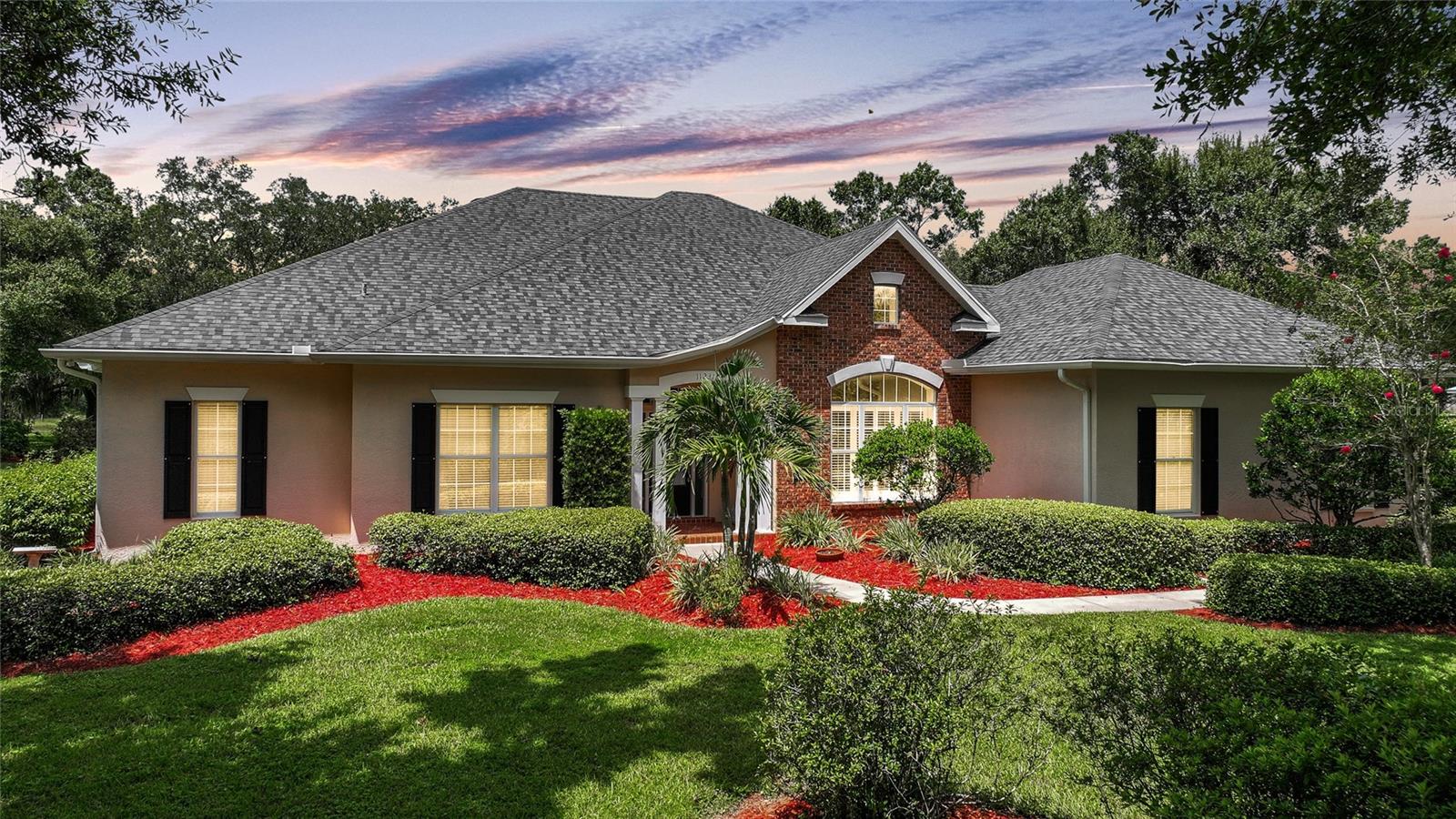 You will LOVE this gorgeous custom built home on an acre of land. As you enter the long driveway you will immediately notice the lush landscaping with mature oak trees, fruit trees and a sprinkler system to help maintain the beauty of this yard. As you make your way to the grand entrance you will notice a formal Dining room, separate Living room and beautiful luxury vinyl flooring. The kitchen is a chef's dream as it was just recently updated with stunning quartz countertops with a waterfall edge off of the center island, lovely white cabinetry and all stainless Steel appliances. While cooking you can still entertain guests as it overlooks the eating area and family room. Upon entering the LARGE Primary bedroom, you will fall in love with the beautiful En Suite as it has gorgeous travertine tile, large walk in shower, garden tub and his & her sinks. This lovely home also features 2 large guest bedrooms, a guest bathroom, 1/2 bath and best of all Large inside laundry room. Newer features of the home include flooing, kitchen, A/C, roof 2019 and solar in 2021 (paid for) and Septic recently pumped and inspected. This home truly is one of a kind with crown molding, trey ceiling, High ceilings and so much more! Be sure to see the video and tour that is attached to this listing.