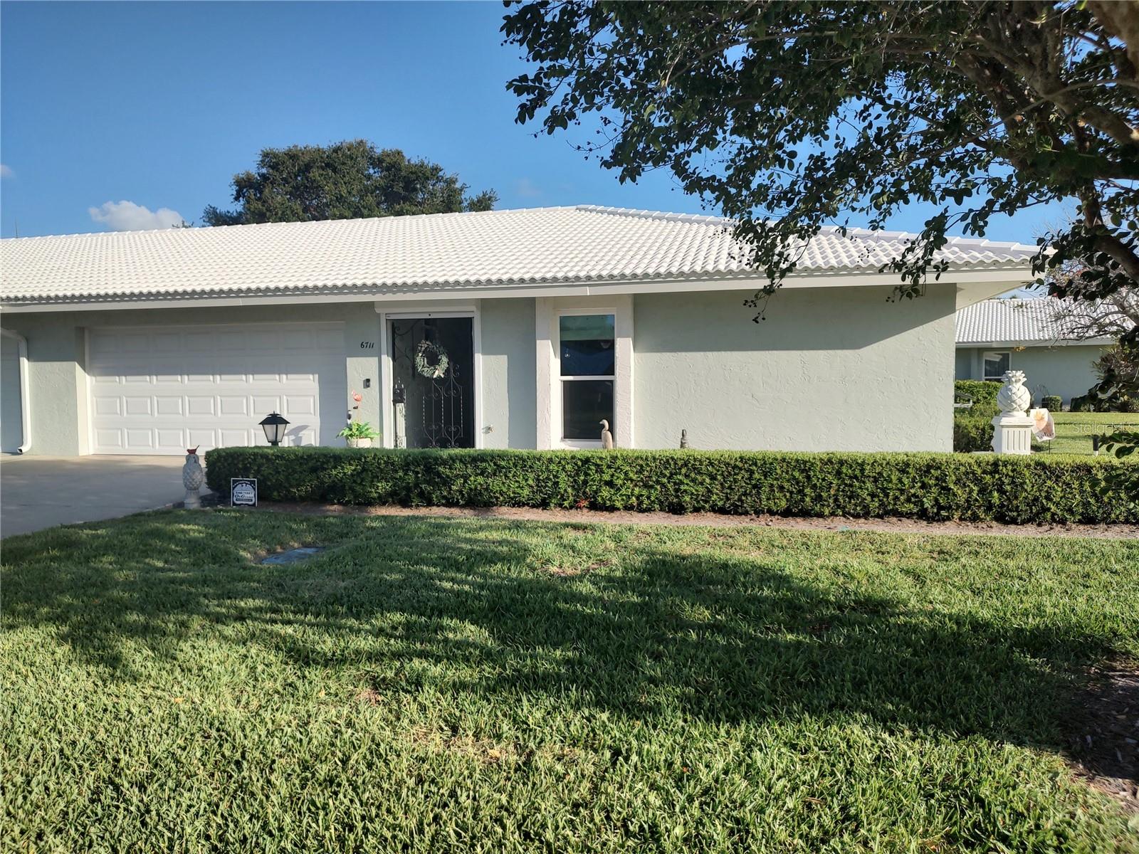 Village Green! This beautiful 2/2 condo with 2 car garage, 2013 Roof, 2014 Hurricane Impact Windows, 2017 Hurricane rated W6 garage door, 2021 Exterior wind shutters 2 and impeccably well maintained home is a must see property. No pets or smokers have ever been in the home. This home is being sold Turn-Key furnished and provides the complete look with the quality finishes. The association includes internet and cable. See community information. No Pets or Leasing allowed. Heated Community Pool. Excellent location for convenient access to beaches, shopping, parks, preserves and many restaurants.