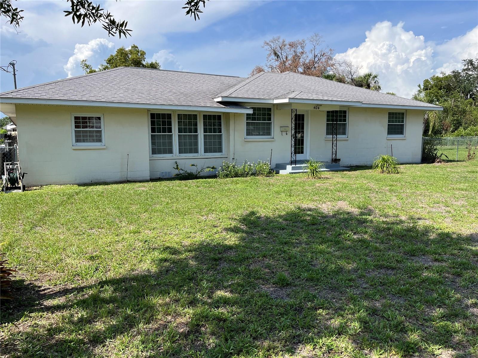 Step into the Charm of this Beautiful Historic home located on a large corner lot with lush landscaping! You will love the original hardwood floors, solid wood doors with original hardware and the bonus claw foot tub. This home has been lovingly maintained and recently completely painted. This is a 2 bedroom/2 bath home with a bonus room that can be easily converted into a 3rd bedroom. The spacious living room with picturesque paned french doors is filled with natural light as well as the cozy breakfast room. One bath is vintage with claw foot tub and 2nd bath has been updated with a large shower. As Hurricane season approaches, you can feel safe with the new hurricane windows. You will enjoy the large screened patio overlooking the manicured back yard which is perfectly fenced and ready for your family and pets. This is a large lot just over half an acre. Three nice storage sheds provide space for your lawn equipment and collectables. Check the added bonus of an assumable FHA mortgage. This is a must see. Call today for appointment!!!!