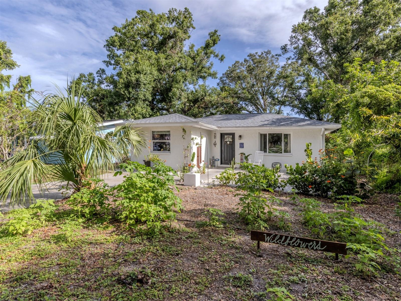 Welcome to this beautifully renovated cottage in the heart of the Edgewood Historic District of Venice. This charming home offers a blend of character, comfort and modern updates, including a new roof (2024), an updated kitchen and bath and a spacious, fully fenced backyard with a large storage shed. Surrounded by mature trees and lush landscaping, this property offers a peaceful retreat just one mile from historic downtown Venice Island and two miles from Venice Beach. A lovely park sits directly across the street, enhancing the serene atmosphere of this quaint neighborhood. Inside, the home features two well-sized bedrooms, one full bath and a versatile screened lanai that offers additional living space, ideal for a studio, home office or relaxing sunroom. The large light-colored tile flooring, large windows and minimalistic décor create a bright, airy and calming environment. The updated kitchen is equipped with stainless steel appliances and offers a delightful view of the backyard garden, filled with blooming flowers and mature greenery. Whether enjoying morning coffee in the lanai or hosting friends in the private backyard, this home invites you to unwind and enjoy the Florida lifestyle. Ideal for a small family, an artist or anyone seeking a peaceful, well-located home, this residence offers timeless charm and modern convenience. See why this inspiring property feels like a hidden gem, you may just fall in love.