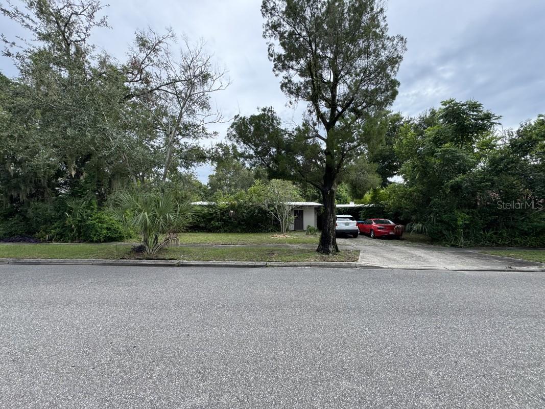 Rare opportunity in the heart of Winter Park! This property sits on a double lot (0.29 acres) — a true rarity in this highly desirable location. The existing 1953 concrete-block home (3 bed / 2 bath) with an attached garage apartment (studio + bath) and shared 2-car carport offers little to no current value and would require a complete renovation. Property will be sold as-is with no repairs. Furniture removal prior to closing is negotiable.
The real value is in the land. With privacy at the end of a quiet street, and a doctor’s office next door, the property is ideally located steps from AdventHealth Winter Park Hospital, Lakemont Center, and just 5 minutes from Rollins College and Park Avenue’s shopping and dining.
The property features a large tree-lined backyard, city water and sewer, cable, and electricity already available. Whether you choose to restore a solid 1950s block home or tear down and build your dream estate while saving on impact fees, this is a prime investment opportunity in one of Central Florida’s most sought-after areas.