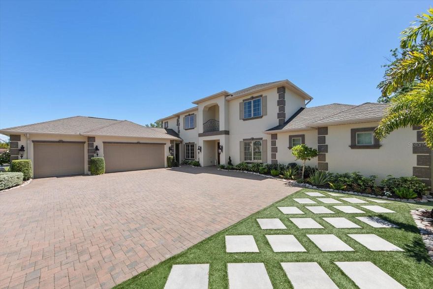 Tucked on a quiet street right across from Belleair Country Club, this exceptional all-block residence delivers the rare combination of thoughtful architecture and extensive upgrades completed within the last year. From the moment you arrive, the professionally re-imagined landscaping, gemstone track lighting, designer lanterns, and resealed paver driveway set an immediate tone of refined curb appeal.
The floor plan is simply incredible. The primary suite is privately situated on the main level and features new chevron-pattern floors, two custom walk-in closets, and a huge luxury bathroom that rivals the finest resorts. From the main living area, oversized sliding glass doors open directly to the pool, creating a seamless indoor-outdoor flow perfect for entertaining or simply soaking in the Florida lifestyle.
The gourmet kitchen is a true showpiece — outfitted for the discerning chef and anchored by a beautifully designed new pantry that keeps everything organized and within reach. All guest bedrooms are thoughtfully positioned upstairs, offering privacy for owners and guests alike. Every interior wall has been insulated for exceptional quiet and energy efficiency, new flooring carries throughout the home office, and Pella windows frame every room with light and confidence.
The home's systems have been thoroughly modernized: two tankless water heaters, a commercial-grade whole-home generator, three new A/C systems — including a dedicated unit for the three-car garage — and an updated elevator all ensure the home runs as flawlessly as it looks.
Step outside to a backyard built for Florida living: new artificial turf, a sparkling pool with fresh equipment and new lighting, new outdoor fans, decorative rock landscaping along the side of the home, and a full perimeter security system for total peace of mind. The roof is top-of-the-line screwed construction — built to last and engineered for the elements. Homes of this caliber — completely move-in ready, on a serene street in one of Pinellas County's most coveted communities — rarely come to market. Schedule your private showing today.
