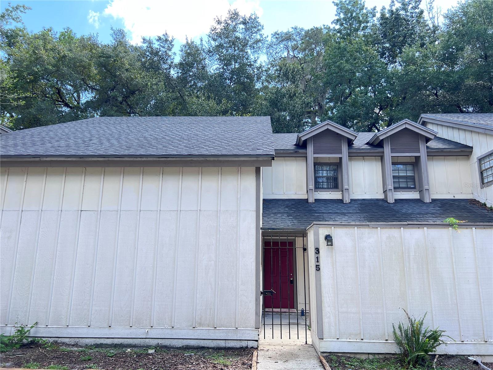 One or more photo(s) has been virtually staged. This beautifully maintained 3-bedroom, 2-bathroom condo in the heart of Gainesville has been thoughtfully updated from top to bottom. The flooring is in great condition, offering a clean and inviting feel throughout. Enjoy peace of mind with a new water heater (2025) and HVAC system (2021). Both bathrooms have been fully remodeled with modern vanities, elegant tile work, and sleek finishes. Stylish lighting fixtures brighten the home and complement its contemporary design. The spacious living area boasts high ceilings and large windows, filling the space with natural light. Step outside to your private back deck ideal for morning coffee or relaxing evenings. Additional highlights include in-unit laundry, ample storage, and reserved parking. Conveniently located just minutes from the University of Florida, Shands Hospital, Butler Plaza, and Celebration Pointe. The HOA covers exterior maintenance, roof, and common areas, making this an easy, low-maintenance property. This condo has been a successful rental investment for the current owners and offers excellent potential for either continued rental income or as a comfortable primary residence. Schedule your showing today and see why this location is so desirable!