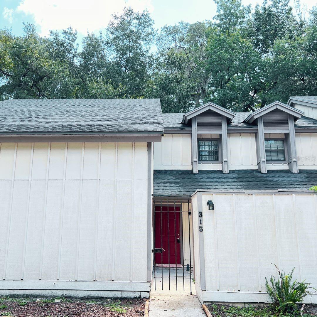 One or more photo(s) has been virtually staged. This beautifully maintained 3-bedroom, 2-bathroom condo in the heart of Gainesville has been thoughtfully updated from top to bottom. The flooring is in great condition, offering a clean and inviting feel throughout. Enjoy peace of mind with a new water heater (2025) and HVAC system (2021). Both bathrooms have been fully remodeled with modern vanities, elegant tile work, and sleek finishes. Stylish lighting fixtures brighten the home and complement its contemporary design. The spacious living area boasts high ceilings and large windows, filling the space with natural light. Step outside to your private back deck ideal for morning coffee or relaxing evenings. Additional highlights include in-unit laundry, ample storage, and reserved parking. Conveniently located just minutes from the University of Florida, Shands Hospital, Butler Plaza, and Celebration Pointe. The HOA covers exterior maintenance, roof, and common areas, making this an easy, low-maintenance property. This condo has been a successful rental investment for the current owners and offers excellent potential for either continued rental income or as a comfortable primary residence. Schedule your showing today and see why this location is so desirable!