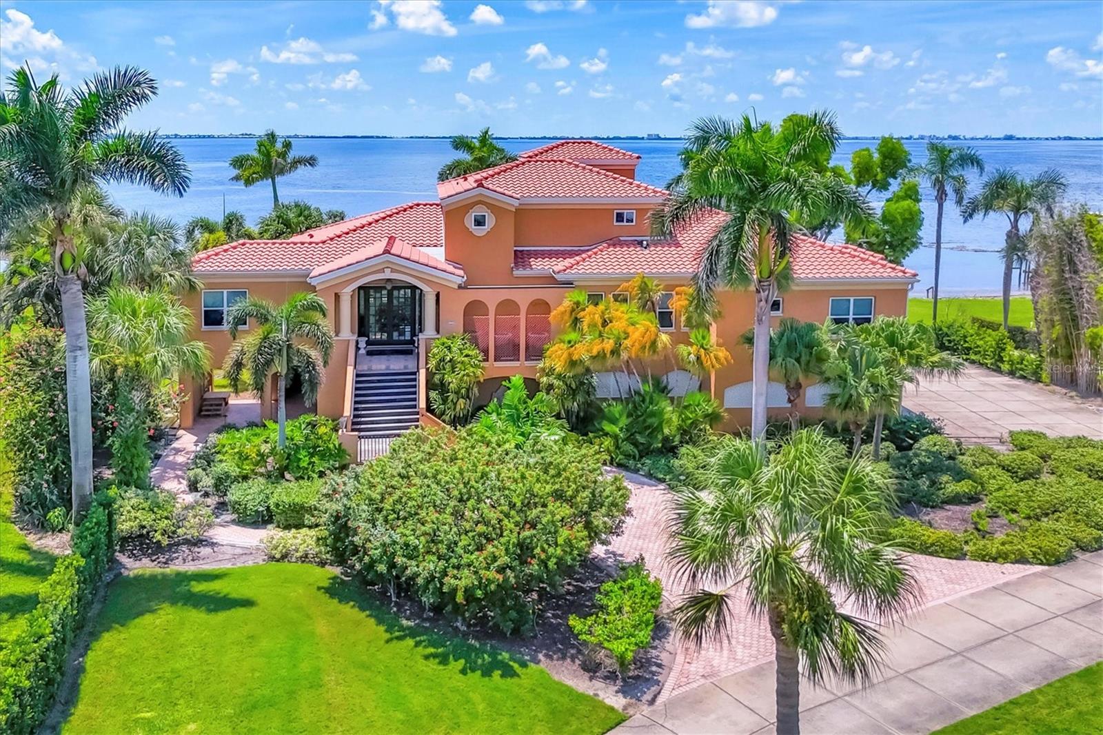 Annual Unfurnished Rental: Tuscan-Style Bayfront Single Family Pool Home. Experience the quintessential Florida lifestyle in this custom-built home by Whitehead Construction and designed by architect Charlie Ugarte. With breathtaking views of Sarasota Bay, the home sits on a sprawling .86-acre estate with 153’ of direct waterfront access. Perfect for water enthusiasts, enjoy boating, kayaking, or simply relaxing while watching dolphins, manatees, and vibrant sunsets. The expansive layout is ideal for entertaining, featuring ample covered outdoor space on the first level and a full-length screened deck on the second floor. The interior boasts flexible living spaces, including two distinct living areas, a formal dining room, and an office/den that can double as a fifth bedroom. High-end finishes abound, with custom built-ins, an elevator servicing all levels, and IPE wood decking. The gourmet kitchen is a chef’s dream, equipped with custom cherry shaker cabinets, granite countertops, a gas cooktop, double ovens, and a breakfast bar. The third-level owner’s suite is a private sanctuary, featuring a balcony with panoramic bay views, a large custom walk-in closet, and a large travertine bathroom. Outdoors, unwind by the heated pool under a shaded pergola. The property also includes an oversized three-car garage and private dock that can be used for pick-ups and drop-offs. Located centrally, this home offers easy access to Sarasota-Bradenton International Airport, IMG Academy, IMG Country Club, Saint Stephen’s, BCS, and the pristine gulf beaches of Anna Maria Island. Downtown Sarasota is 20 minutes away for even more dining, entertainment, and shopping options. Lawn and pool maintenance are included.