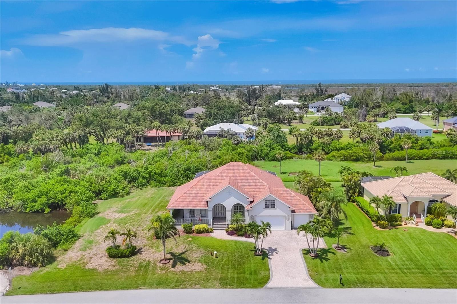 Welcome to this exquisitely crafted estate, custom built in 2011 and perfectly positioned on a rare double lot with lake views front & side and untouched natural beauty. Thoughtfully designed for both elegance and comfort, this residence offers a seamless blend of refined luxury and relaxed Florida living. Step inside to soaring ceilings and an expansive open-concept great room, anchored by premium custom cabinetry, high-end stone countertops, and an elite appliance package. Designer lighting and fan fixtures add stylish flair throughout the home. The generous front porch invites you to relax and enjoy serene golf course and lake views, while the rear lanai overlooks the tranquil Amberjack Creek, creating a peaceful retreat.
The home features: 4 spacious bedrooms, plus a versatile bonus room above the garage, 3 full bathrooms and a half bath, oversized 3-car garage with ample room for vehicles and storage, an impressive 66' x 28' pool and patio area, ideal for both grand entertaining and intimate gatherings. Meticulously maintained and offered fully furnished, this home is truly move-in ready. This Estate Home is the perfect setting for hosting guests while maintaining privacy and comfort. Located just minutes from historic Boca Grande, pristine beaches, world-class fishing and boating. This Estate home provides coastal living at its finest.