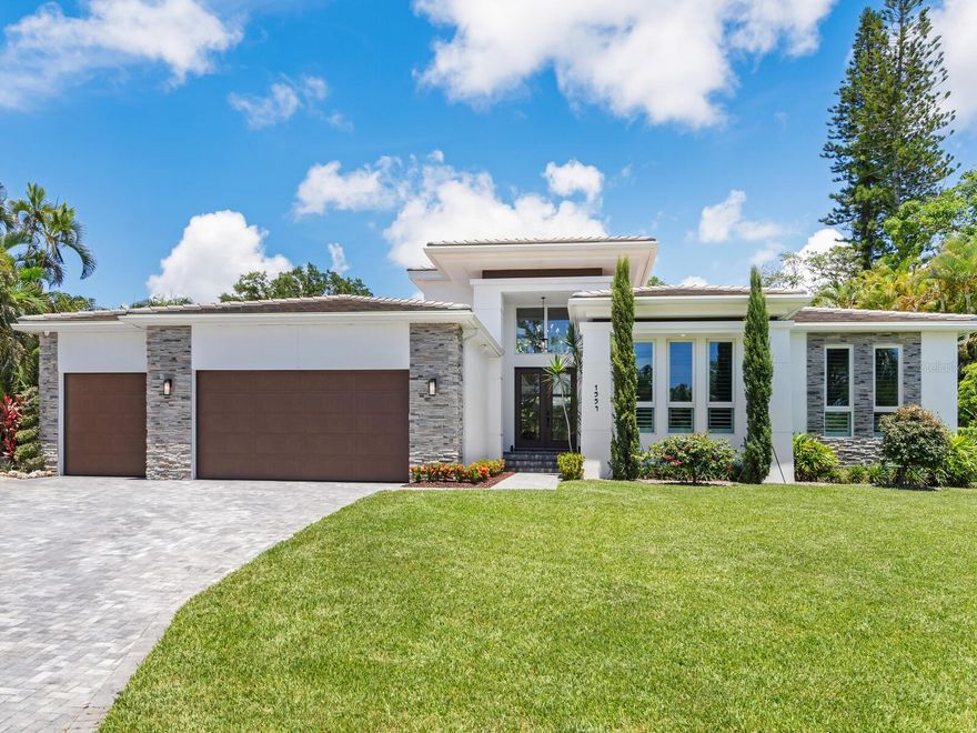 This property doesn’t just offer a home; it promises a lifestyle that anticipates your every need and creates a perfect canvas for both entertaining and quiet family life. Anticipation is heightened as you approach 1554 Eastbrook Drive, showcasing an unparalleled blend of casual elegance, inviting ambiance and dynamic architectural nuances. Nestled within a highly popular West of Trail neighborhood renowned for its upscale living, this 3 bedroom, 4.5 bath home was thoughtfully curated to elevate your lifestyle and provide an immersive living experience like no other. The close proximity to charming downtown and Siesta Key’s north bridge allows for convenient access to a wide variety of amenities such as celebrated recreational pleasures, top-rated schools, extensive shopping, diverse dining options, and vibrant cultural attractions…all just a short distance from your front door. The 3,048 sq. ft. floor plan flows flawlessly from the beautiful foyer entry to an impressive two-story family room which serves as the centerpiece of the home. Adorned with stunning volume ceilings and a sleek electric fireplace, the family room’s floor-to-ceiling glass sliders open to cohesively blend indoor and outdoor living into one incredible space. With ultra-luxury brand appliances and elevated finishes, the gorgeous kitchen caters to the culinary enthusiast with well-planned space where every detail reflects luxury and functionality. The fabulous dining area offers a built-in buffet with wine cooler and a private patio with French doors allowing the delicate evening nectar of blossoming plants to permeate the room. Offering a sense of enhanced space and privacy, the owner’s suite is a sanctuary of serenity with built-in automatic black-out shades and a spa-like bath retreat with luxurious fixtures created for added relaxation and enjoyment. An oversized wardrobe room with designated his and her spaces is also included within the bounds of this fabulous retreat. Two additional ensuites are well-appointed and designed to accommodate both family and guests comfortably. A serene backdrop of lush greenery is the ultimate backdrop to this lush tropical oasis anchored by a heated and cooling pool with 3-tiered spa, a fire pit for night-time ambiance, and an adjacent covered gathering area with fully-equipped kitchen. The bonus room opens on two sides to become additional leisure or entertaining space and features built-in automatic shades, a full bath, and a wet bar. Elongated windows and ten-foot ceilings invite natural light throughout the home. The triple sliders in the study open wide as if extending an invitation to the second covered poolside lanai. Many other features include a 3-car garage with epoxy finished floor, 6 Sonos TVs, premium-level security system, extra French drains and termite traps installed around the house, bidet toilet with heated seats, 500-gallon propane generator, upgraded can lighting in bedrooms, hand showers in all bathrooms, reverse osmosis water-treatment system, professionally designed landscape, irrigation well, brick paver courtyard and pool deck, tankless gas water heater, and 18 SEER 3-zoned A/C. Indulge in the ultimate expression of luxury living where every moment is an opportunity to savor the finer things in life!