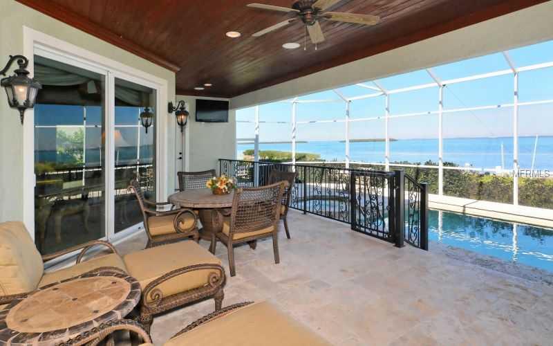 DIRECT BAY FRONT Views greet you upon entering the front door and are never ending as you make your way through this one of a kind custom maintenance free home located in the resort community of the Longboat Key CLub. Redesigned & reconstructed in 2006, taken down to the slab and exterior walls extended to an additional 1200 sq.ft. , it's like no other. Labeled a "smart home" with the latest technology it has all the bells and whistles. For comfort and function the residence features 4725 sq.ft. under air all on one level with a covered lanai and poolside grill for outdoor enjoyment.The extravagant master suite enjoys its own private side of the house, separate from the other 3 bedroom suites, and boasts an adjacent executive style office. The floor plan is open with a nice ease of transition from living room, dining, family, entertainment bar, and kitchen with custom hardwood cabinetry making use of every inch of space. Well thought out by the gourmet chef of the family the kitchen features 3 dishwashers, 2 full size subzero refrigerators with freezer drawers, Wolf gas cooktop, double ovens, island prep center, lots of storage cabinets, and walk-in pantry. From the imported Italian stone flooring to the 20-25'ceilings, floor to ceiling impact windows and the spectacular bay front location, you know your are in a special residence. A new composite dock with electric, water, lift and kayak dock rounds out the outdoor features. A membership to the Bay Isles Beach Club is included.