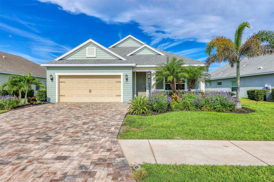 RAVISHING RIVERS REACH WATERFRONT RETREAT!!! Tucked inside the GATED COMMUNITY of Rivers Reach, this beautifully maintained waterfront residence delivers the Florida lifestyle buyers are after — open, airy living paired with PEACEFUL WATER VIEWS and low-maintenance ease. From the moment you arrive, the CUSTOM WIDENED PAVER DRIVEWAY, manicured landscaping, and charming covered front porch create an inviting first impression that immediately feels like home. Step inside to find RICH WOOD FLOORING flowing seamlessly throughout, complemented by HIGH CEILINGS THROUGHOUT that enhance both space and natural light. The open-concept layout is clean, functional, and designed for the most discerning present-day buyer. At the center of it all, the kitchen features granite countertops, a tasteful tile backsplash, and solid wood cabinetry with ample storage — all overlooking the main living area to keep everything connected. The great room is anchored by a TRAY CEILING that adds depth and character, while large sliding glass doors draw your eye out to the lanai and beyond. Step outside to your screened-in outdoor living space, where one can sit sipping on a cup of their favorite brew whilst taking in the morning breeze and serene view of the water’s edge, creating a private setting that’s equally suited for quiet mornings or relaxed evenings. A versatile den/media room with a custom sliding barn door adds flexibility for a home office or additional living space, while the owner’s retreat is highlighted by a FULLY RENOVATED EN-SUITE MASTER BATHROOM WITH A BREATHTAKING WALK-IN SHOWER, delivering a true spa-like experience. The home’s guest bedrooms and bathroom maintain the same clean, move-in-ready feel, while a thoughtfully designed laundry room with added workspace and storage enhances everyday functionality. Residents of Rivers Reach enjoy access to a resort-style pool and spa, fitness center, playground, and scenic walking trails — all just minutes from Lakewood Ranch and University Town Center. Whether you're looking for a full-time residence or seasonal retreat, this home delivers where it matters most. IN A SEA OF SUB-PAR NEW CONSTRUCTION HOMES THAT LEAVE SO MUCH TO BE DESIRED…OPPORTUNITIES LIKE THIS DON’T LAST — SCHEDULE YOUR PRIVATE SHOWING TODAY, BEFORE THIS ONE SLIPS THROUGH YOUR GRASP AS WELL!