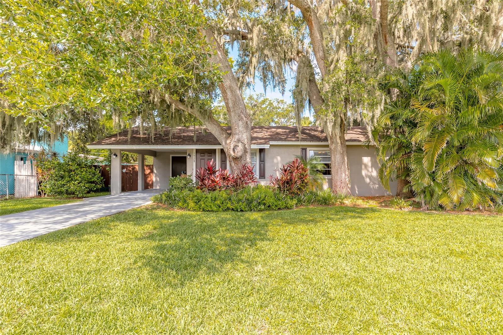 Welcome to this beautifully maintained, move-in ready home! This gem sits high and dry, on a 10,000 sqft lot with NO FLOODING. Tile floors in main areas, custom built kitchen with granite countertops, breakfast bar, stainless steel appliances (2024) and newer electrical, plumbing and AC (2023) Enjoy relaxing on the covered back deck overlooking a gorgeous, one of a kind, lush garden and fully fenced yard. The backyard is home to native flowers, fruit trees, grapevine-covered arbors and has been meticulously and organically maintained with beauty and safety in mind. (A list of all plants is available) There is a private outdoor shower to cool off on hot Florida days and plenty of room for a pool. Located in a very desirable location with no HOA- bring your toys- and just minutes from US-1, I-95, shopping, schools, parks and fabulous New Smyrna Beach.