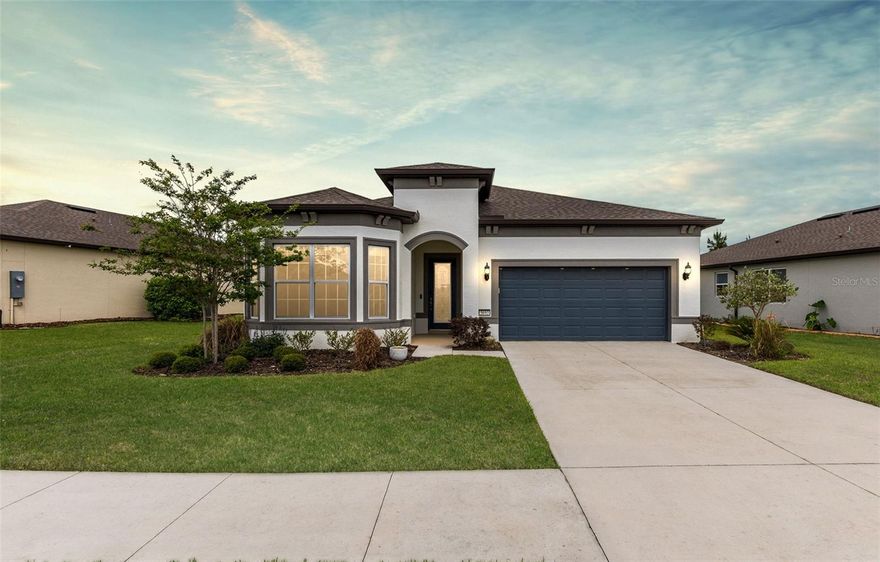 Situated within the gated 55+ Stone Creek Golf Course Community, renowned for its luxurious resort-style amenities, this beautifully appointed Prestige model home blends modern sophistication with smart functionality for a truly elevated living experience. Offering 2 bedrooms, 2.5 baths, and a flexible bonus room, and your very own golf cart, every inch of this home is thoughtfully designed with privacy, versatility, and comfort in mind. Step into the contemporary open-concept layout where lofty ceilings, recessed LED downlighting, and staggered plank tile flooring tie together the gathering room, café, and kitchen, perfect for both everyday ease and effortless entertaining. The gathering room showcases a detailed accent wall and wide glass sliders that open to the screened lanai and the fenced backyard, complete with a patio designed for effortless outdoor entertaining. At the heart of the home, the chef’s kitchen impresses with a large island ideal for meal prep and casual dining, crisp Shaker-style cabinetry, gleaming quartz countertops, a statement tile backsplash, a walk-in pantry, and sleek stainless steel appliances. Positioned at the back of the home for optimal privacy, the Owner’s Suite offers a quiet space to retreat and a large walk-in closet with convenient pass-through access to the laundry room. The spa-inspired en suite bath features a quartz-topped double sink vanity, a Roman-style walk-in shower with elegant glass tile accents, a private water closet, and a transom window that bathes the space in soft natural light. The generously sized secondary bedroom, perfect for guests or flexible living, features a walk-in closet,  a charming bay window, and its own full bath complete with a linen closet. Additional highlights include a guest-friendly powder room, a dedicated interior laundry space, 2" faux wood blinds throughout, and a Smart Home package featuring a video doorbell. You'll also appreciate the whole-home surge protector for peace of mind, a water softener system, and a spacious two-car garage with overhead storage and durable epoxy-coated flooring. Step beyond this thoughtfully designed home and into a vibrant, amenity-filled community where each day feels like a retreat. With a 24/7 staffed gated entrance ensuring both security and peace of mind, you'll enjoy comfort, connection, and convenience at every turn. Luxury-inspired amenities include heated pools, a state-of-the-art fitness center, a spa, and relaxing hot tubs and saunas. Stay active with pickleball, bocce, tennis, and a softball field, while a dedicated lifestyle staff curates entertainment, activities, and special events to foster connections. Just beyond the gates, enjoy a golf course, pro shop, and restaurant, perfect for socializing and unwinding. Make your move today and experience resort-style living at its finest!